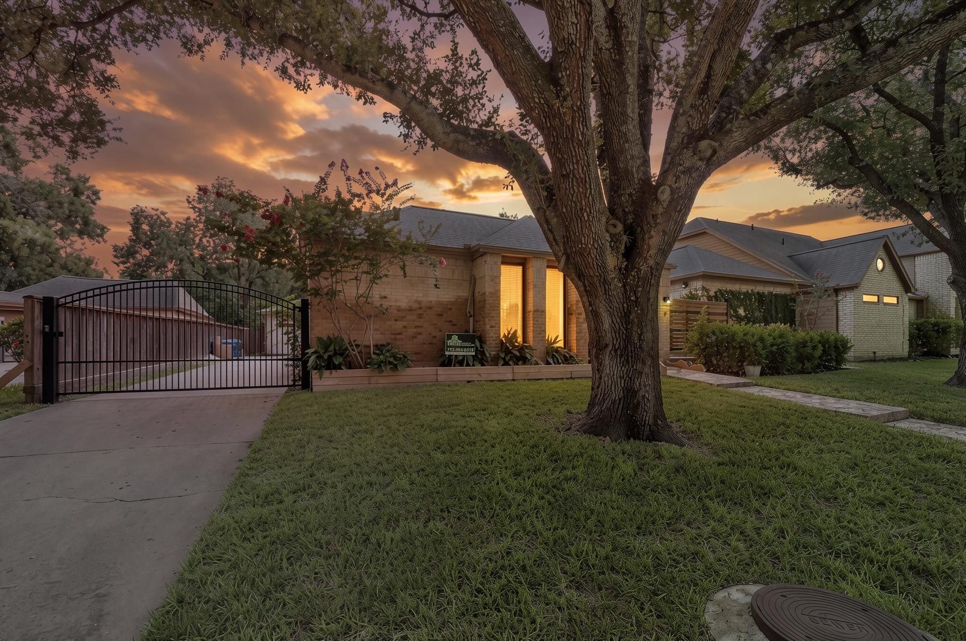 11807 Carriage Hill Drive, Houston, TX 77077 The gated driveway adds a more private approach to the property while keeping access to the detached garage simple. It gives the home a polished exterior detail that pairs well with the mature landscaping.