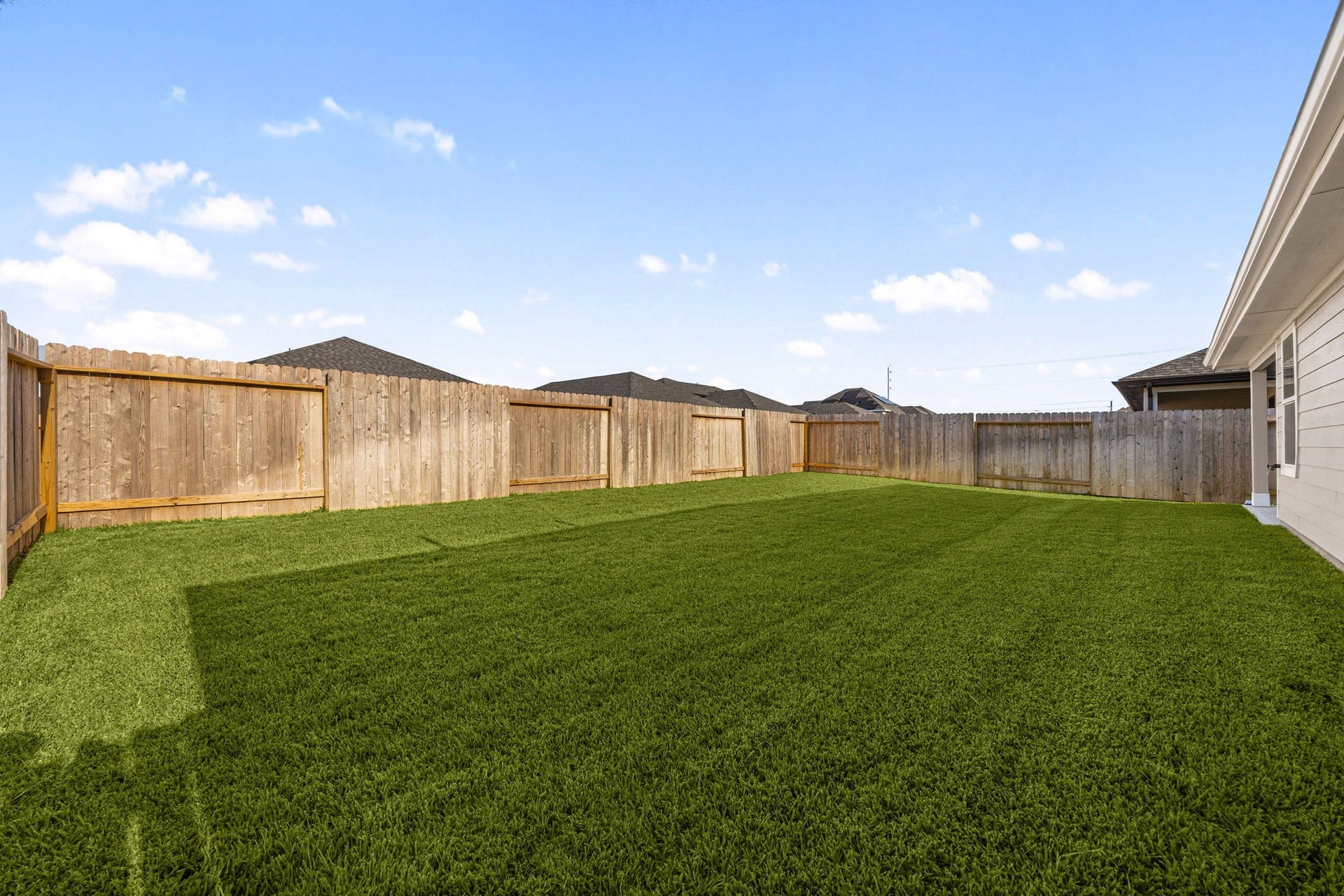 The fully fenced backyard offers plenty of green space, ideal for pets, play, or future outdoor gatherings.