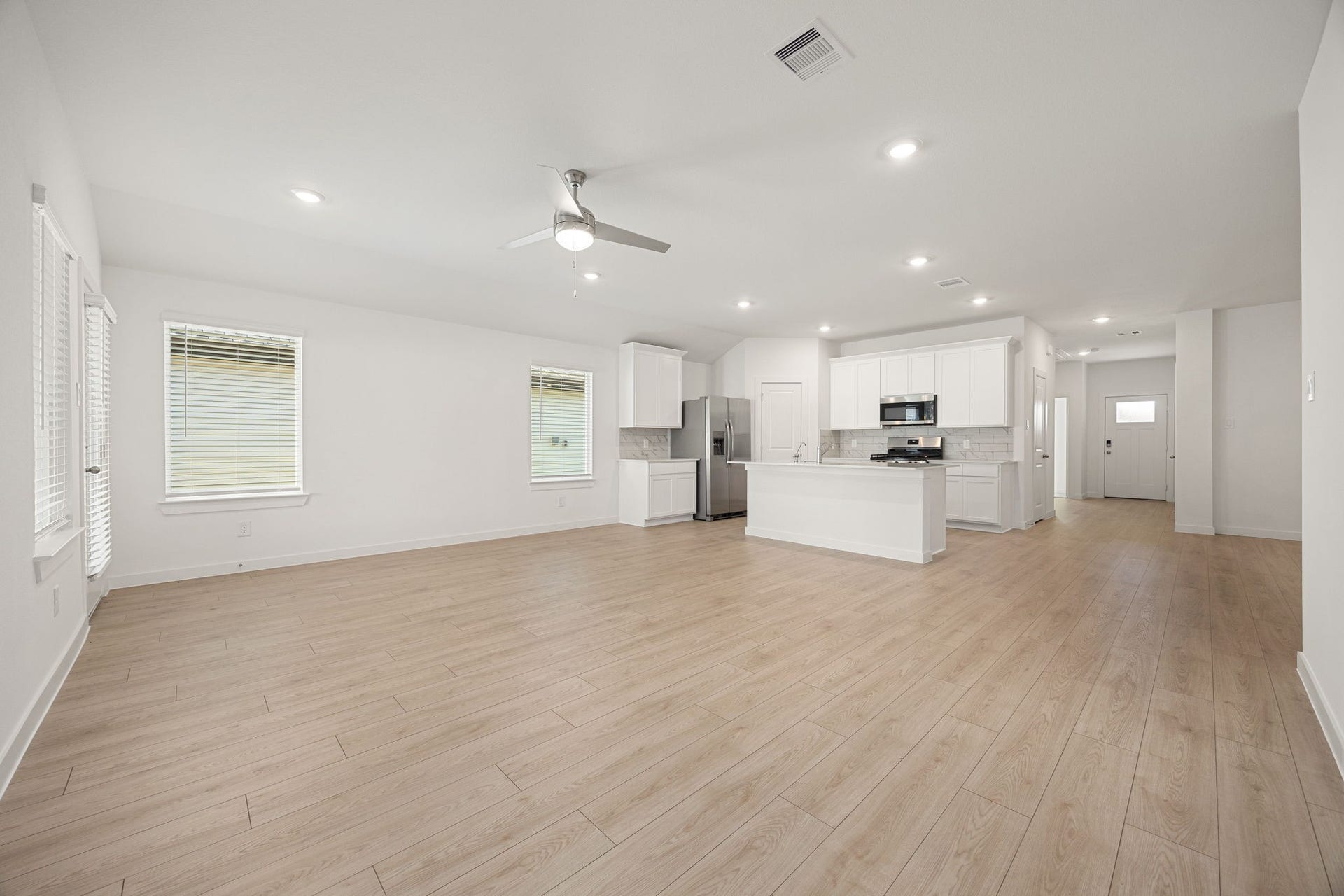 Another view of the living area showcases the seamless flow into the kitchen, perfect for everyday living and entertaining.