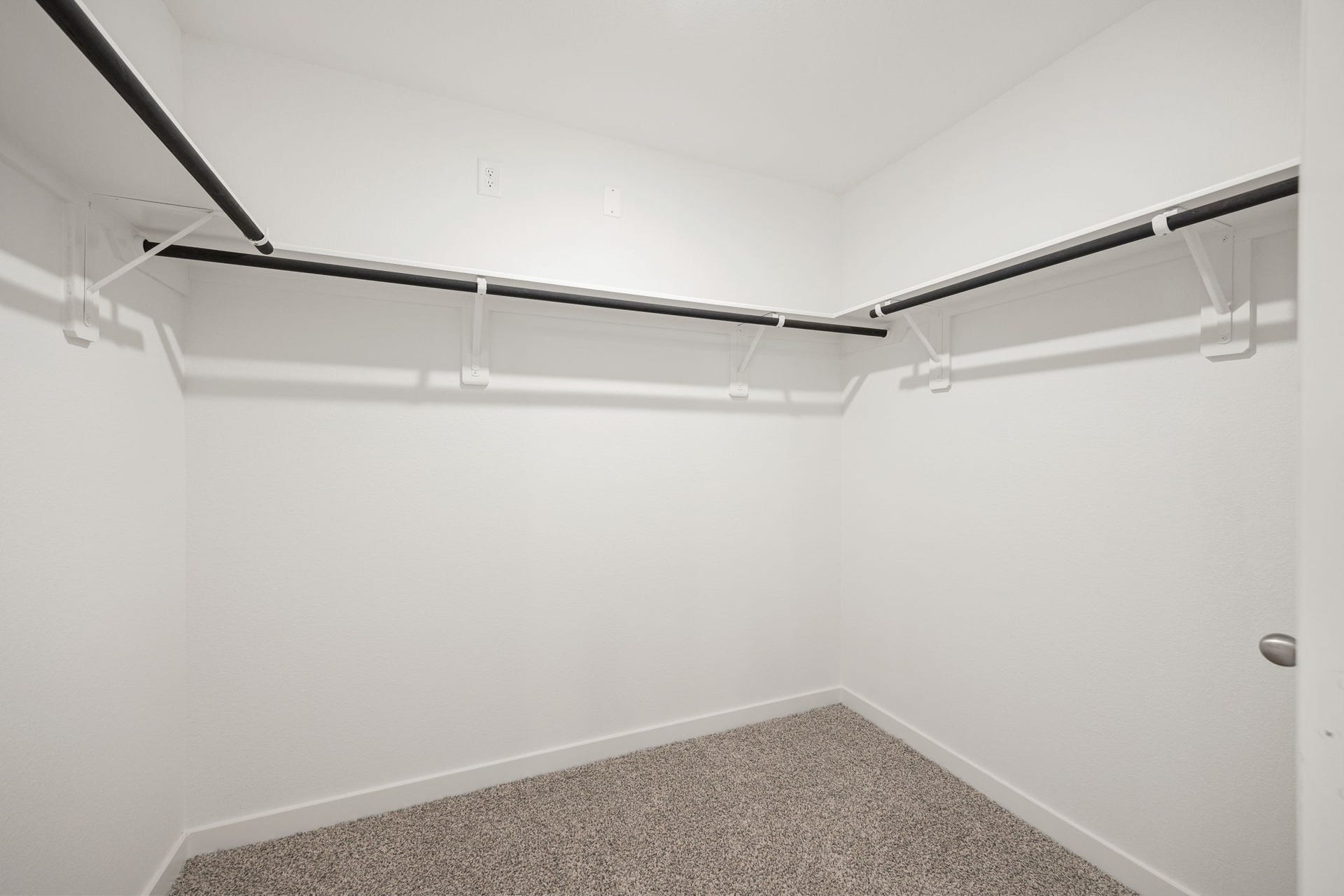 The primary closet offers generous built-in shelving and ample hanging space to keep everything organized.
