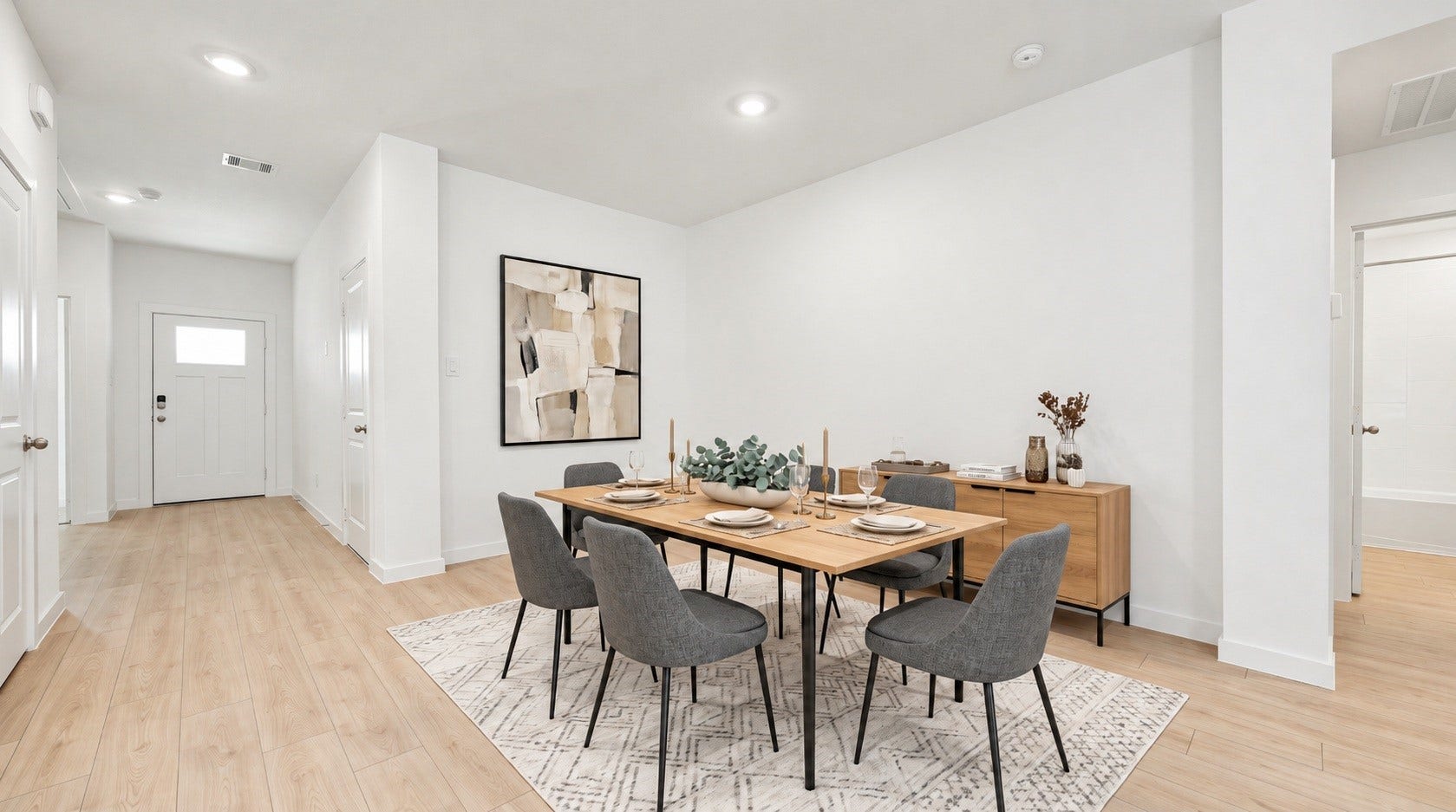 The dining area offers an open, flexible space just off the entry, ready to be styled to fit your table and decor. Virtually staged.