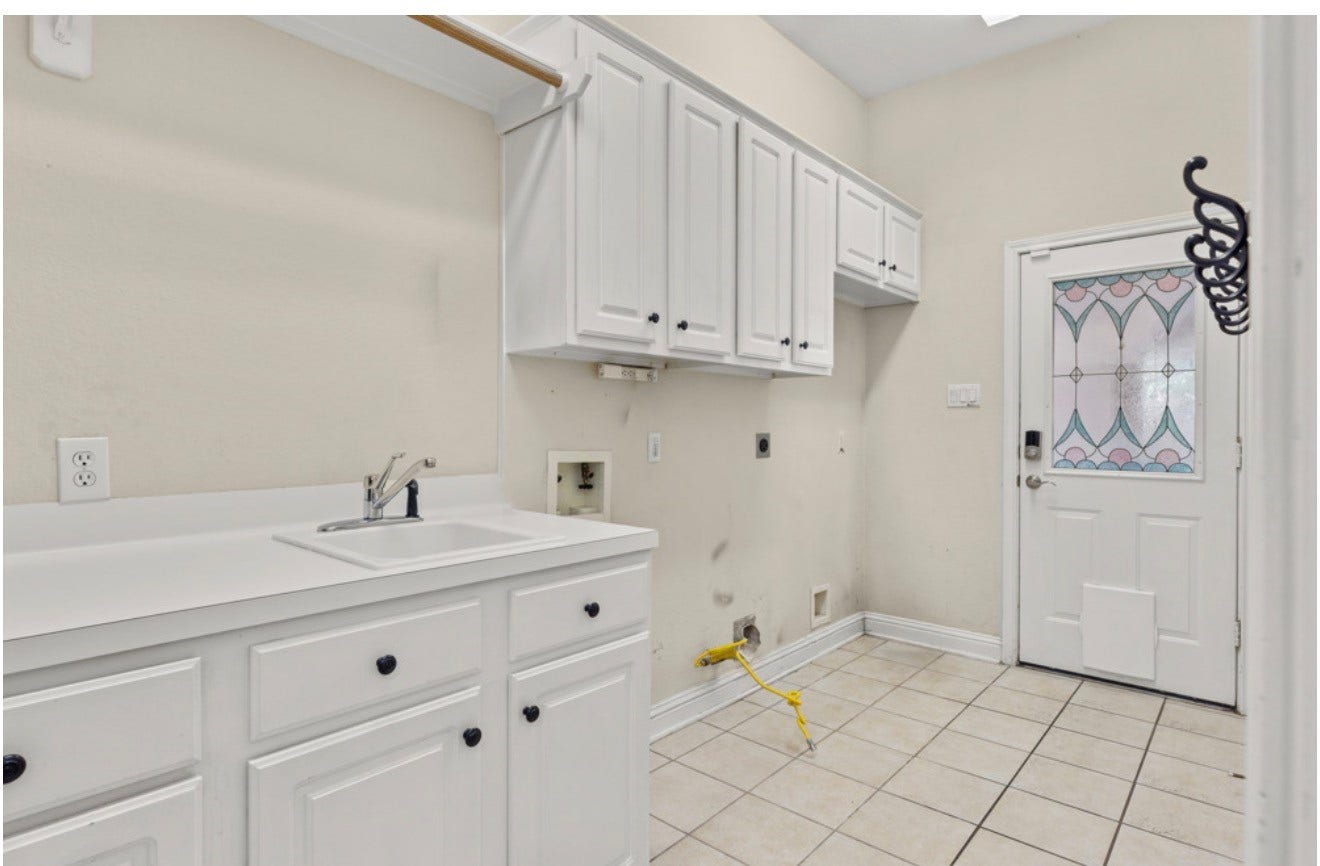 2831 Hazy Hillside Court, Houston, TX 77345 Laundry is room with sink and cabinets. Enough space for another fridge if desired