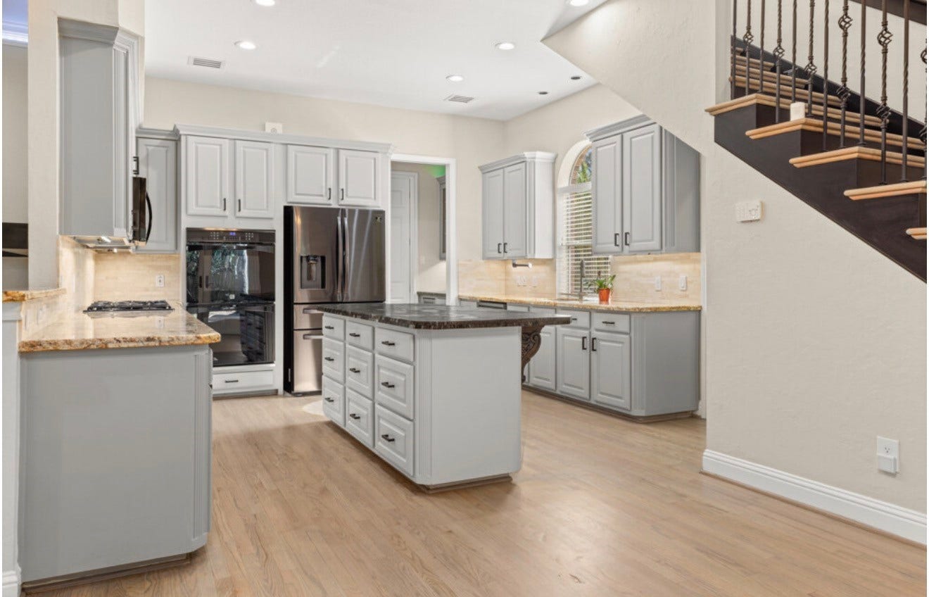 2831 Hazy Hillside Court, Houston, TX 77345 Kitchen with the second stair access. Double ovens and a large island