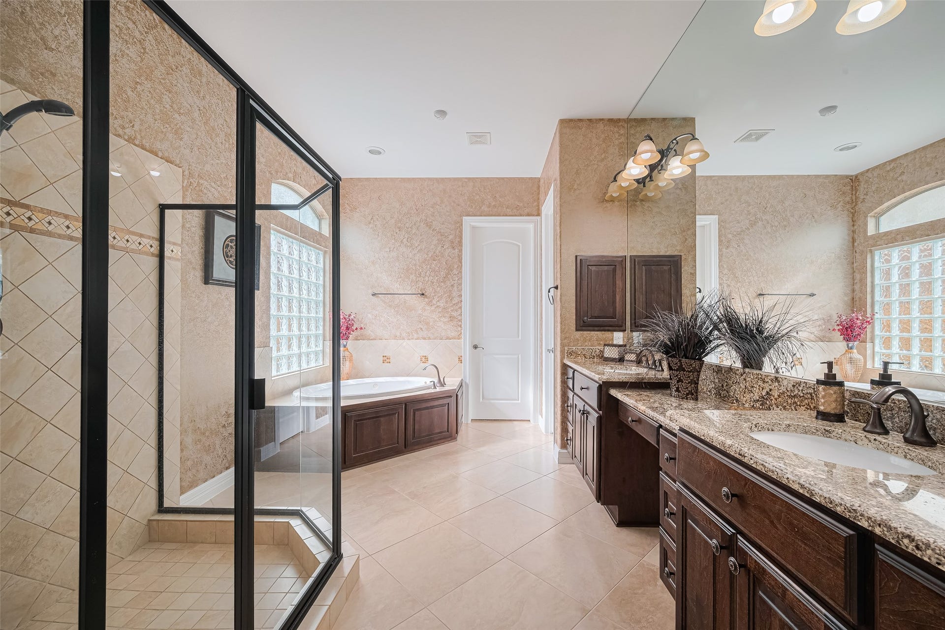 4722 Burclare Court, Sugar Land, TX 77479 Luxurious primary bathroom featuring a glass-enclosed walk-in shower, relaxing soaking tub, extended granite vanity, and generous cabinetry.