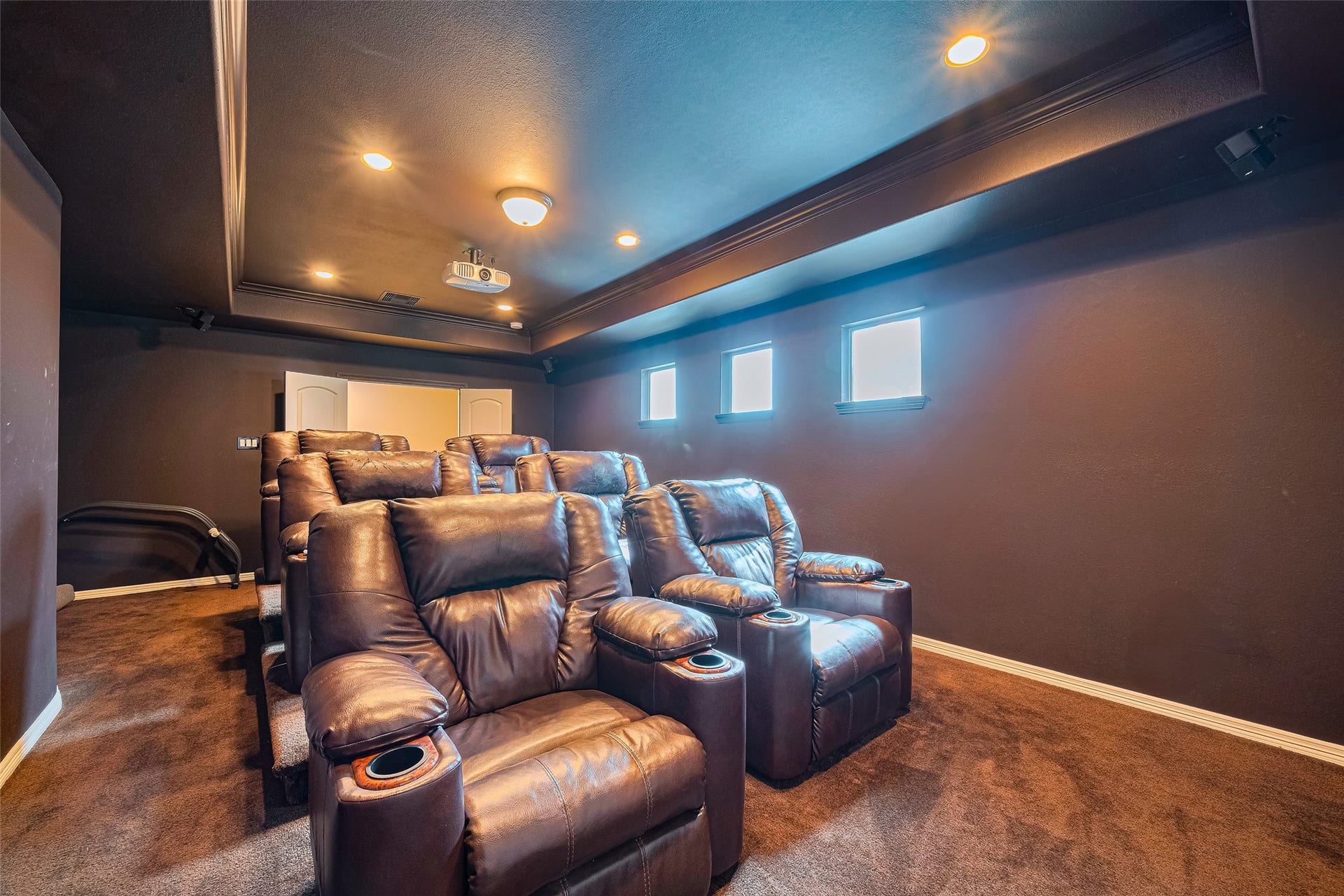 4722 Burclare Court, Sugar Land, TX 77479 Reverse theater view showcasing plush reclining seats arranged across multiple tiers beneath recessed lighting for a true cinematic experience.