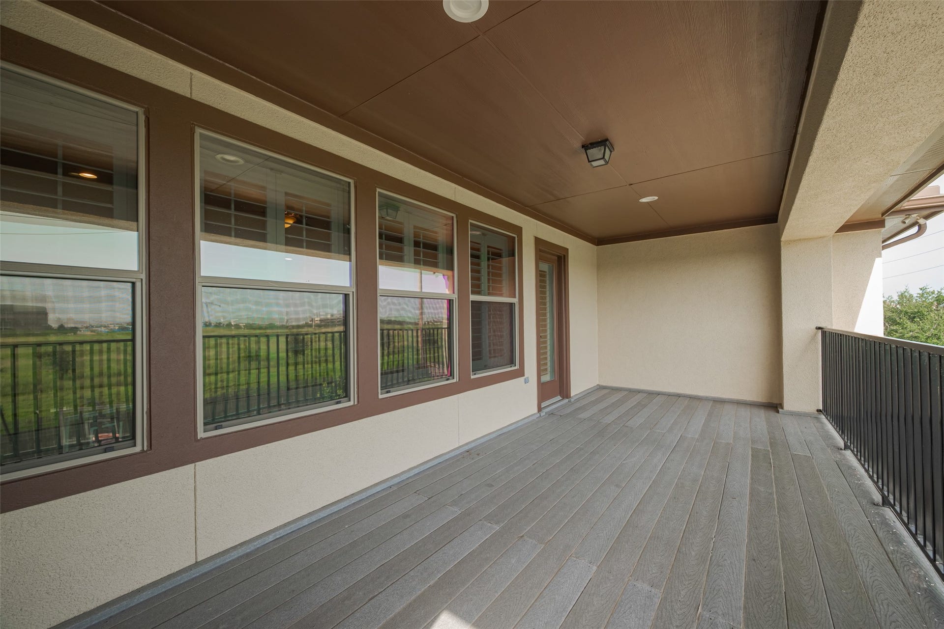 4722 Burclare Court, Sugar Land, TX 77479 Spacious covered balcony offering ample room for outdoor seating and relaxation with open views beyond.