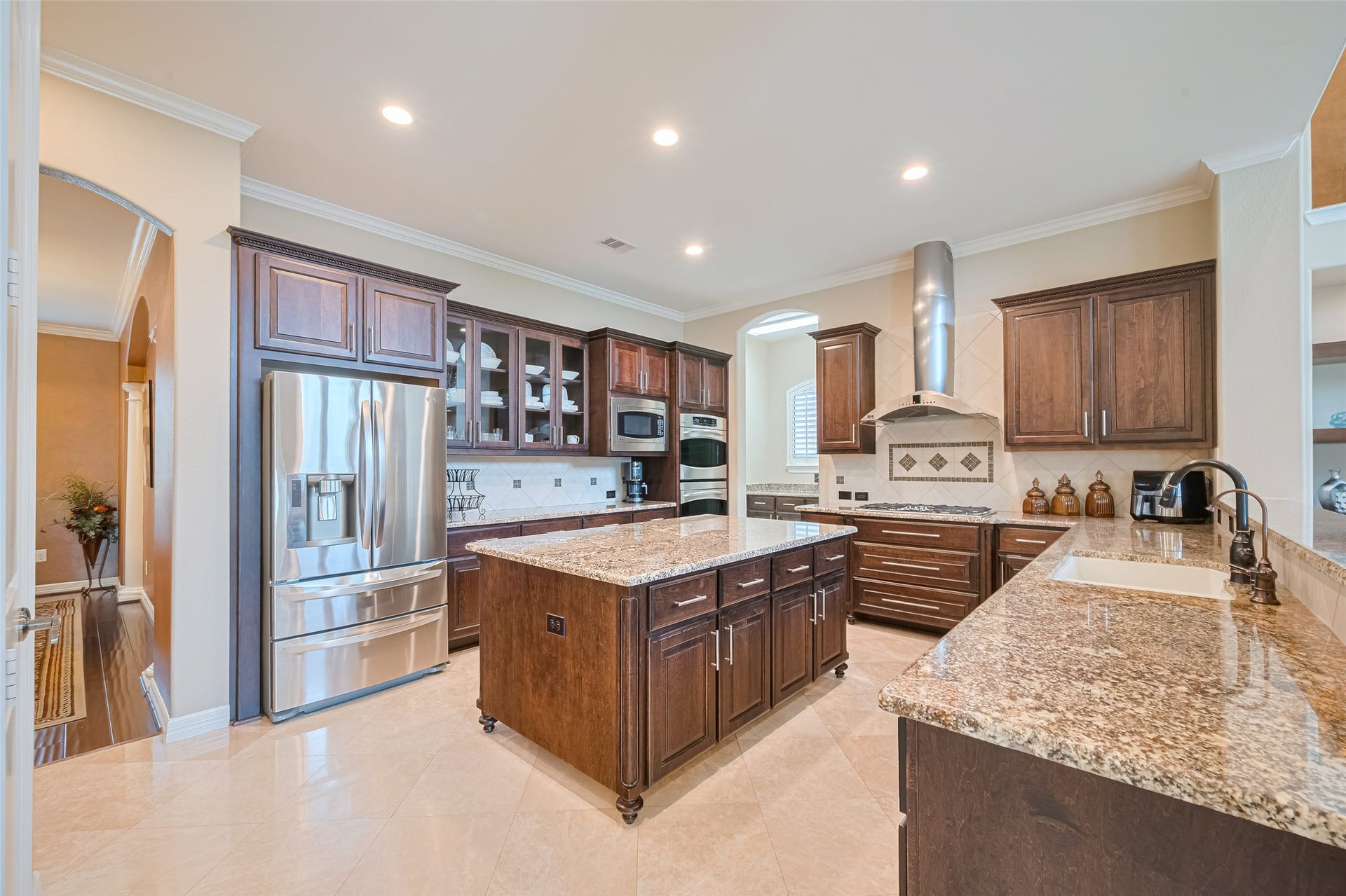 4722 Burclare Court, Sugar Land, TX 77479 Gourmet kitchen equipped with granite countertops, abundant custom cabinetry, stainless steel appliances, and a generous center island.