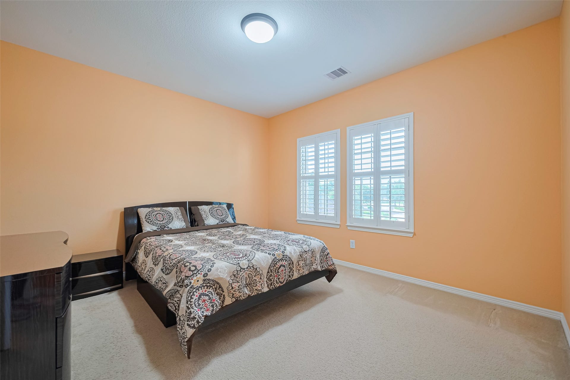 4722 Burclare Court, Sugar Land, TX 77479 Spacious fourth bedroom featuring warm tones, plush carpeting, generous natural light, and ample room for comfortable furnishings.
