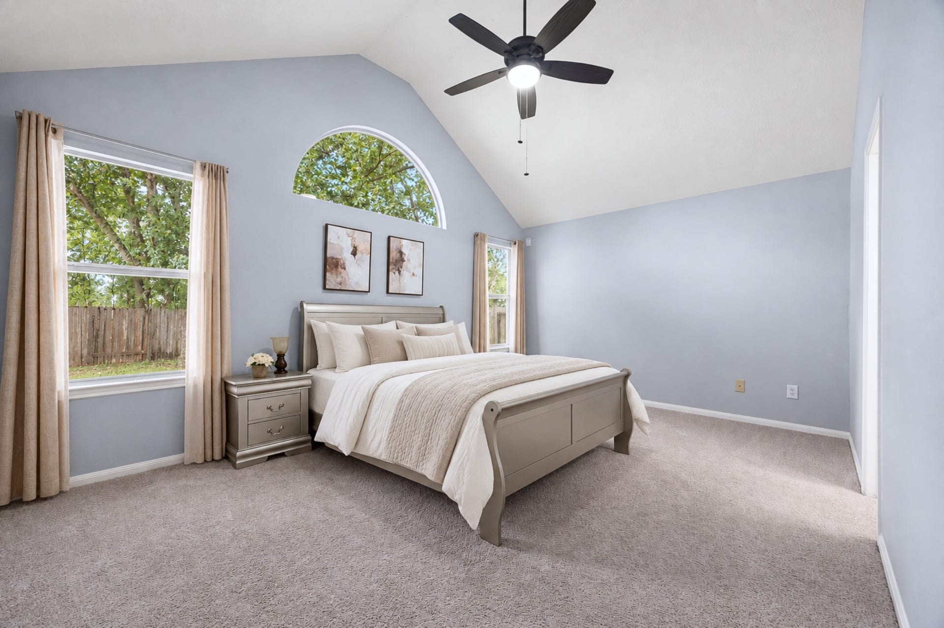 4807 Lake Wichita Lane, Richmond, TX 77407 Primary bedroom with a vaulted ceiling and arched transom window, plus direct access to the en-suite bath and walk-in closet.