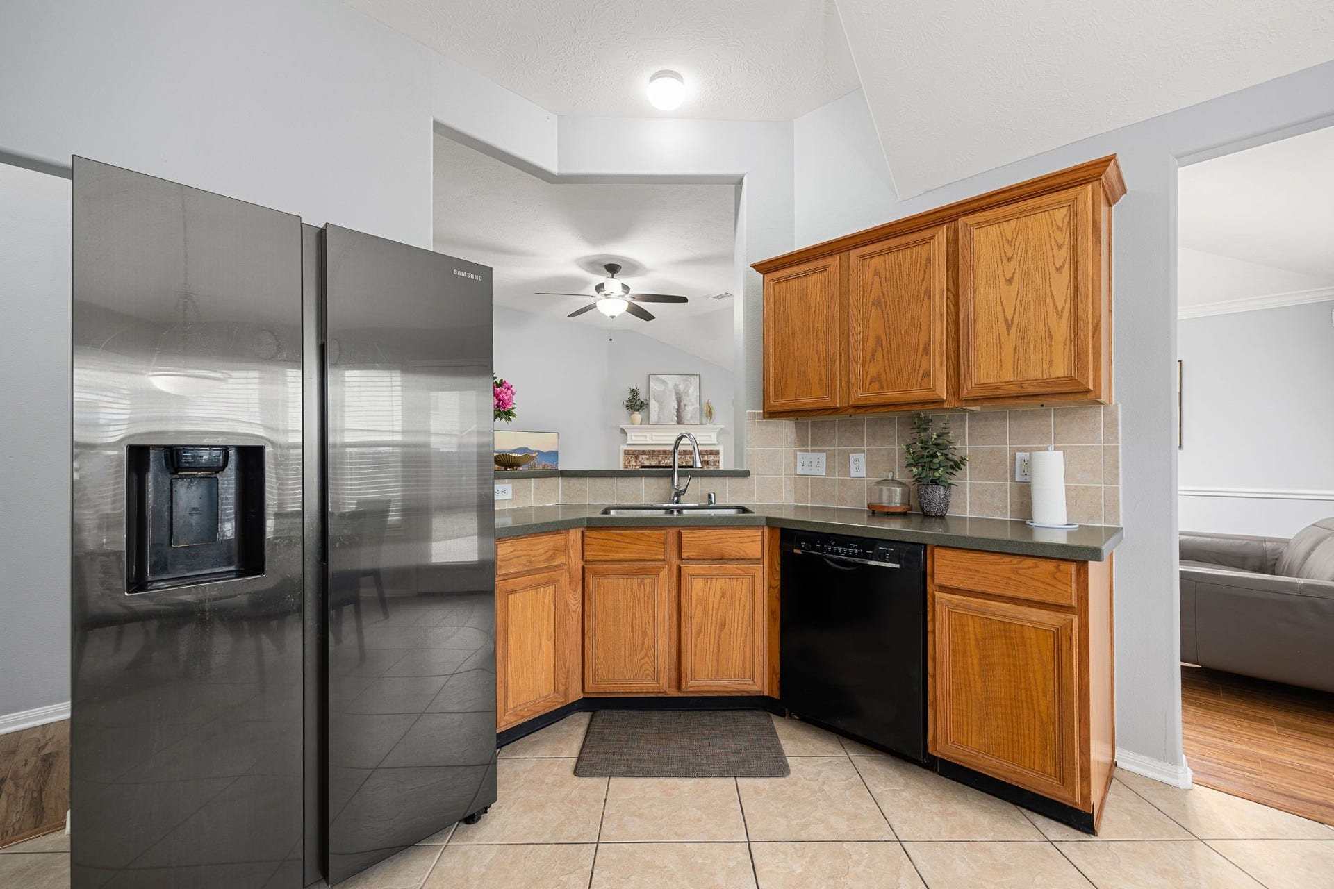 4807 Lake Wichita Lane, Richmond, TX 77407 Kitchen with wood cabinetry, a gas range, and a pass-through opening to the living area.