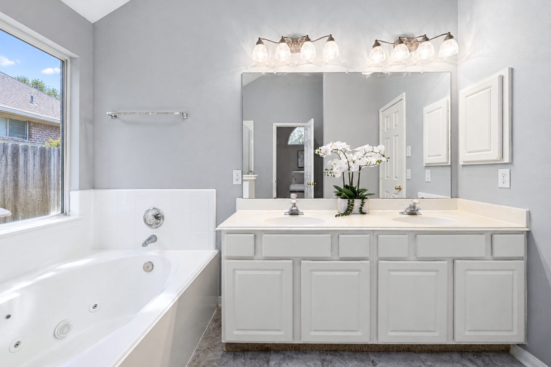 4807 Lake Wichita Lane, Richmond, TX 77407 Virtually decluttered Primary bath with dual sinks, a jetted soaking tub, a separate glass-enclosed shower, and a walk-in closet.
