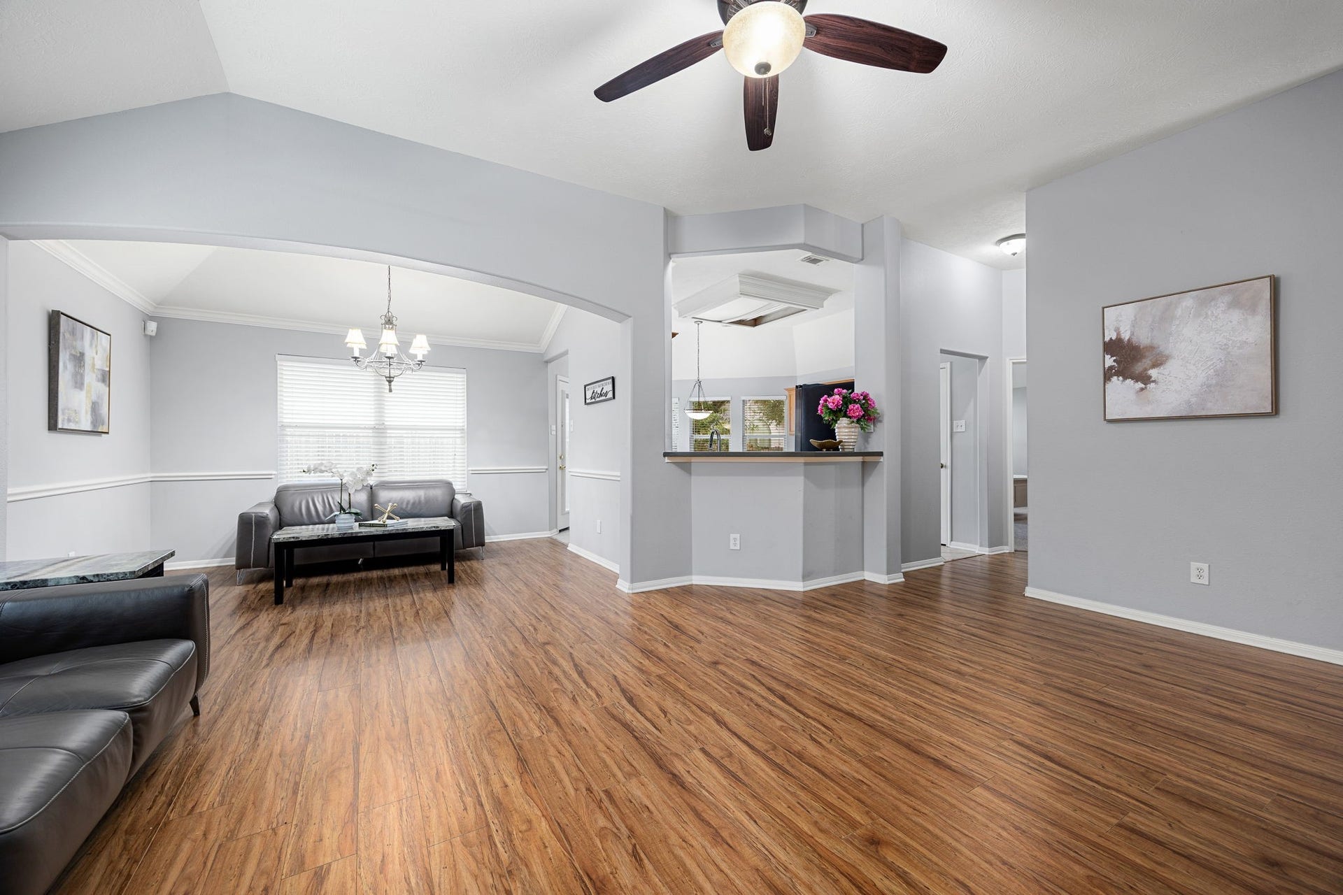 4807 Lake Wichita Lane, Richmond, TX 77407 Dining room with crown molding, chair rail, and a chandelier, connected to the living area through the arch.
