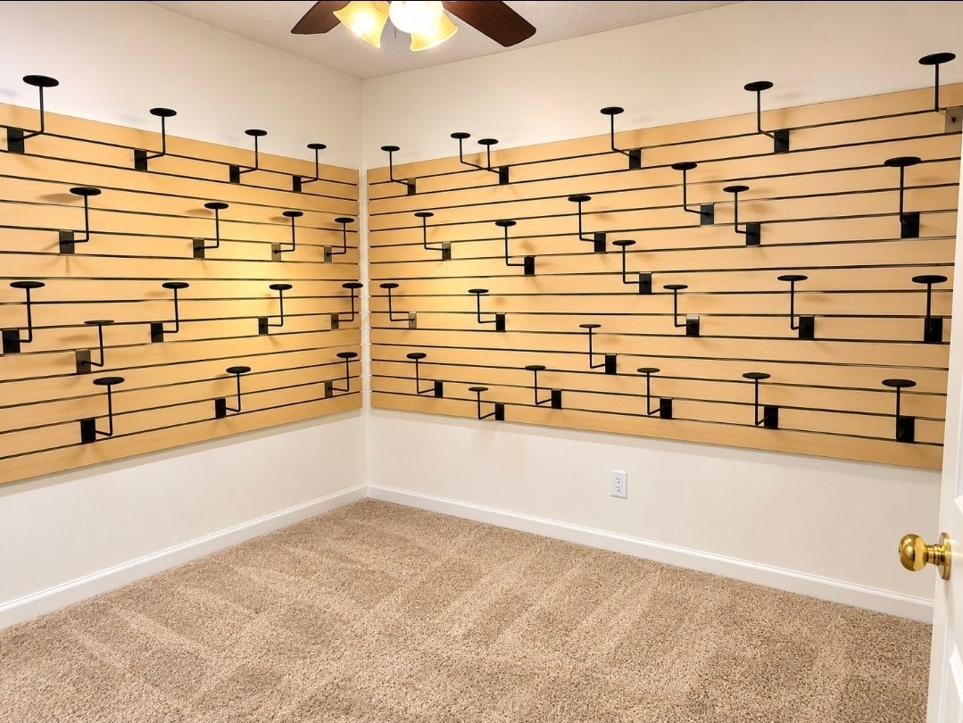 7929 Talton Street, Houston, TX 77028 Versatile room featuring slatwall panels with adjustable brackets, perfect for customizable storage or display, complemented by cozy carpet flooring and a ceiling fan.