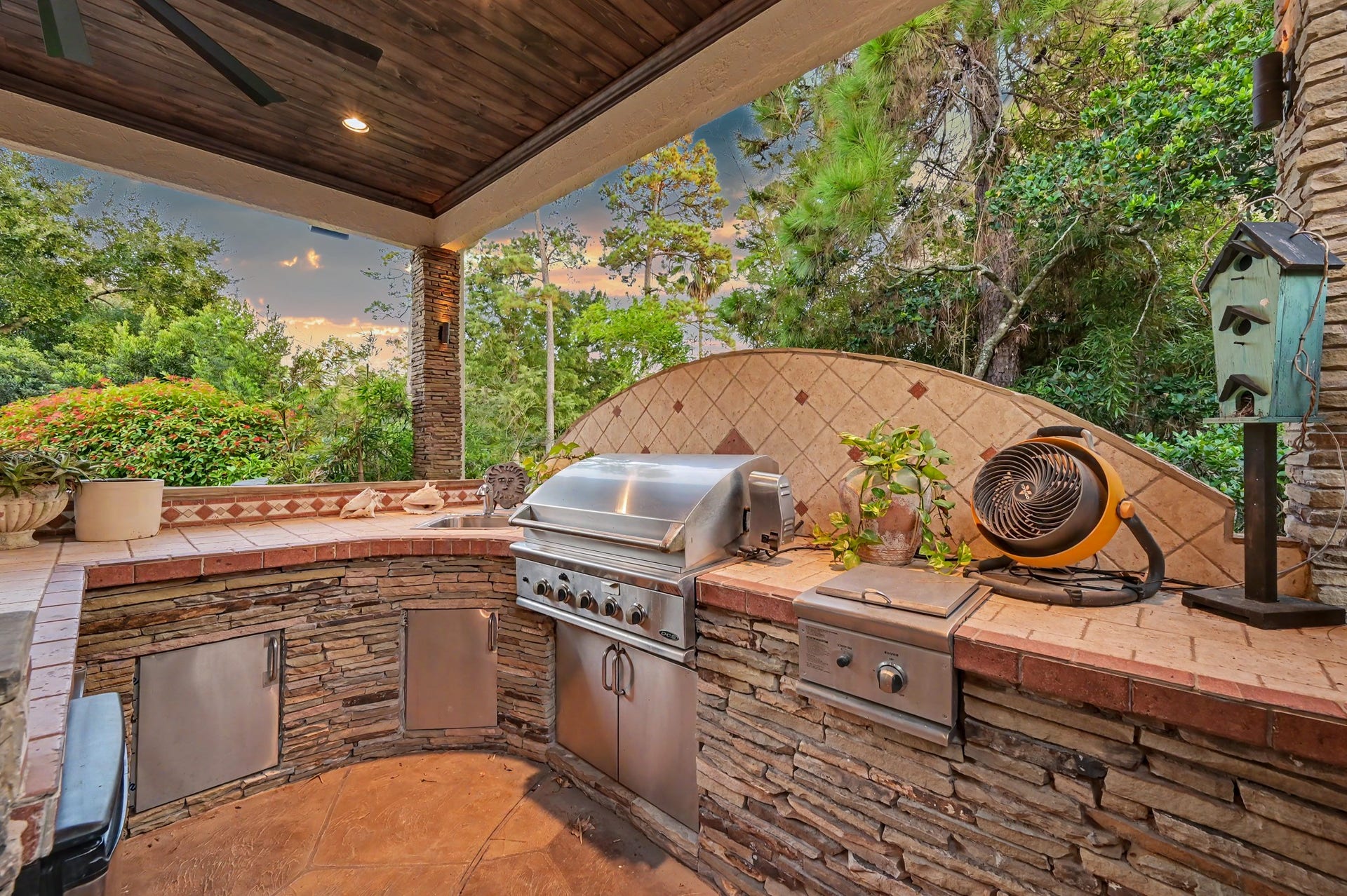 Fully equipped outdoor kitchen featuring a built-in stainless steel grill, generous counter space, and custom stoneworkperfect for outdoor entertaining.