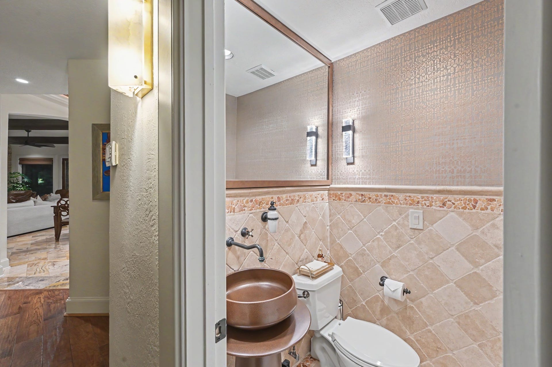 Stylish powder bath featuring a beautiful floating sink