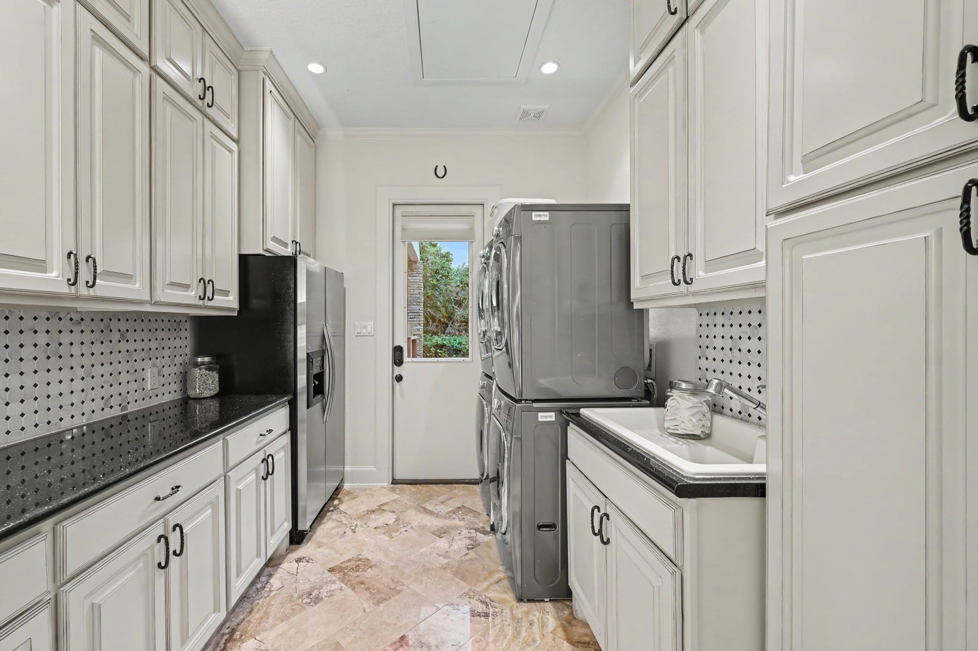 Laundry room featuring a sink as well as dual washer and dryer hookup