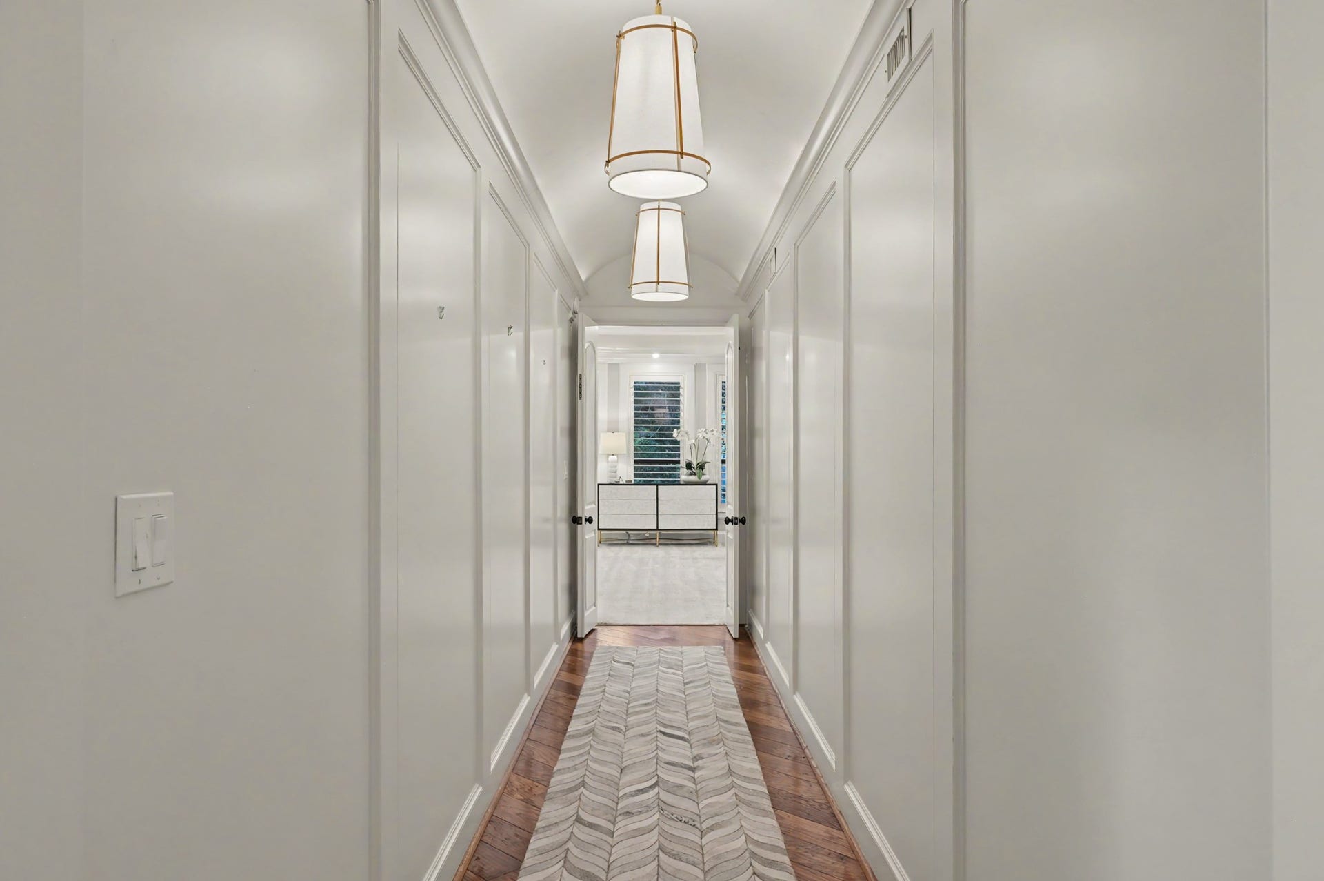 Dramatic long hallway which leads to master suite.