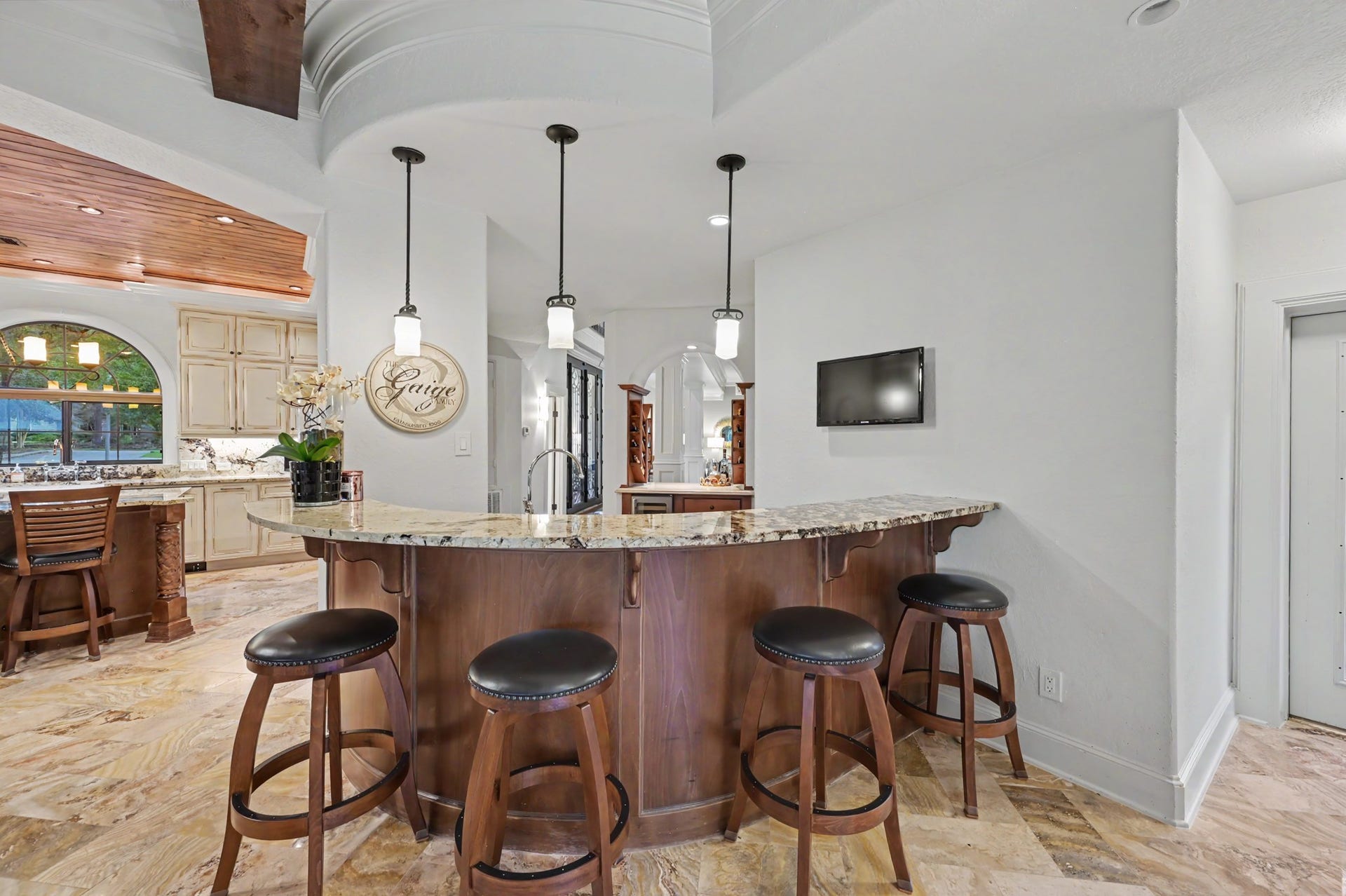 Bar with seating that connects formal dining and wet bar to the living room. Makes entertaining guests easy.