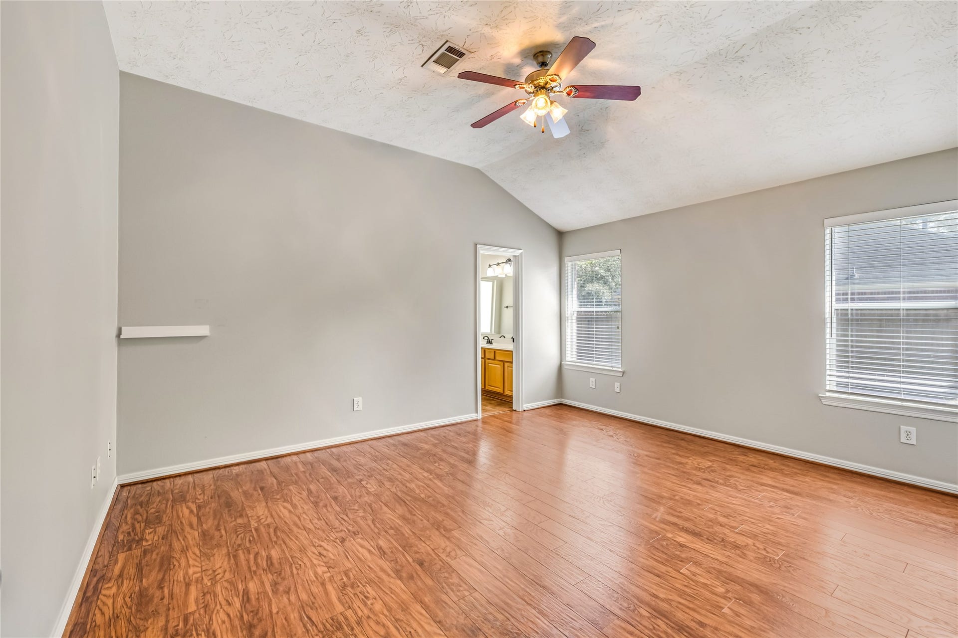 914 Mesquite Drive, Magnolia, TX 77354 The primary bedroom has natural light and a ceiling fan as well as an en suite.