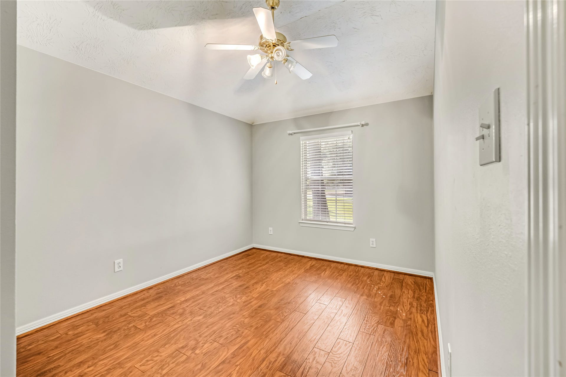 914 Mesquite Drive, Magnolia, TX 77354 Bedroom 2 has a ceiling fan a view of the front yard.