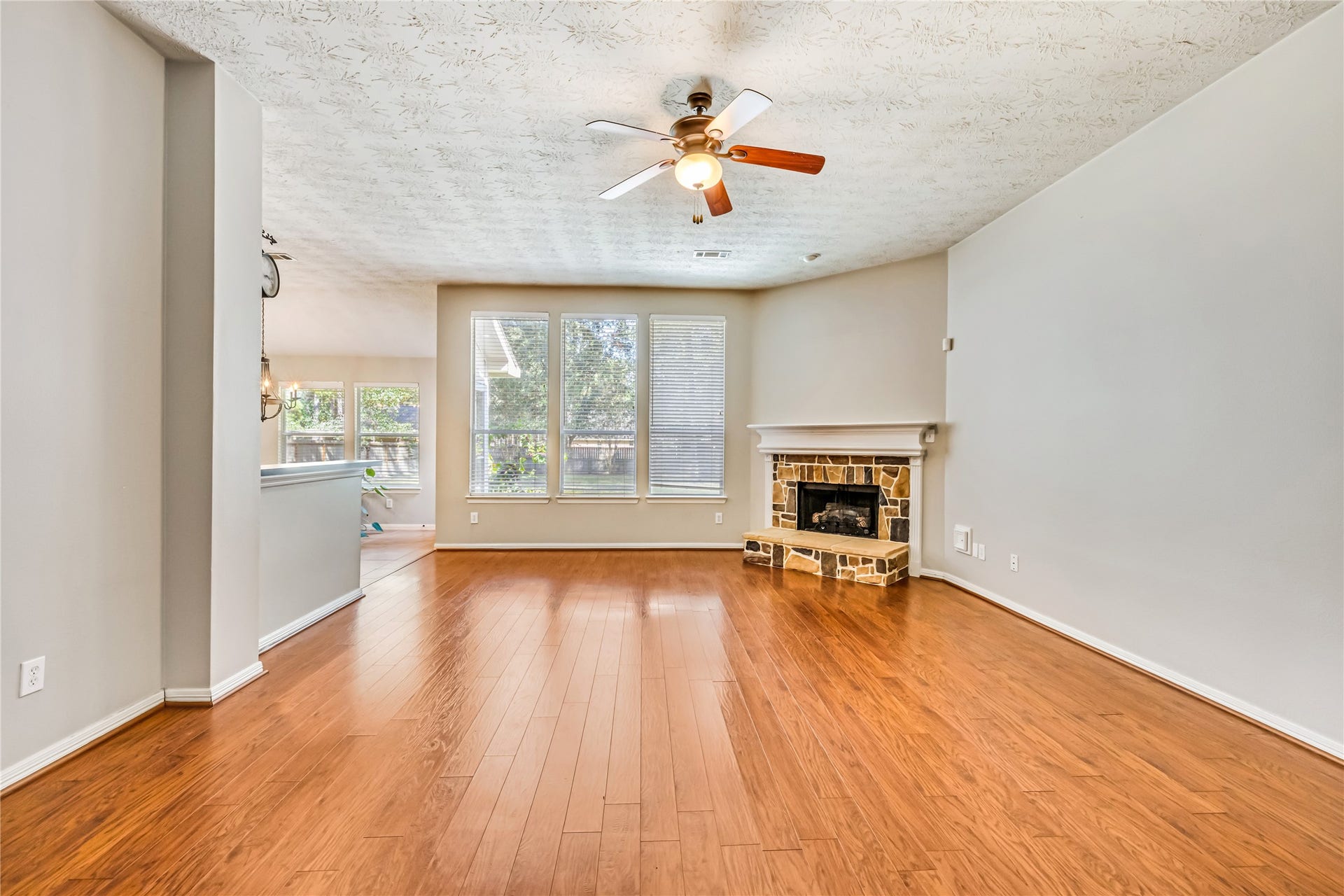 914 Mesquite Drive, Magnolia, TX 77354 Clear view from the front door, through the spacious living room and window filled wall to the large back yard