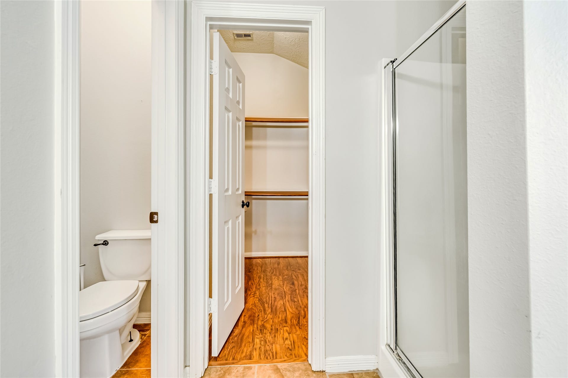 914 Mesquite Drive, Magnolia, TX 77354 En suite has a separate room with a door for the toilet area and a separate shower as well as a walk in closet with beautiful wood flooring.