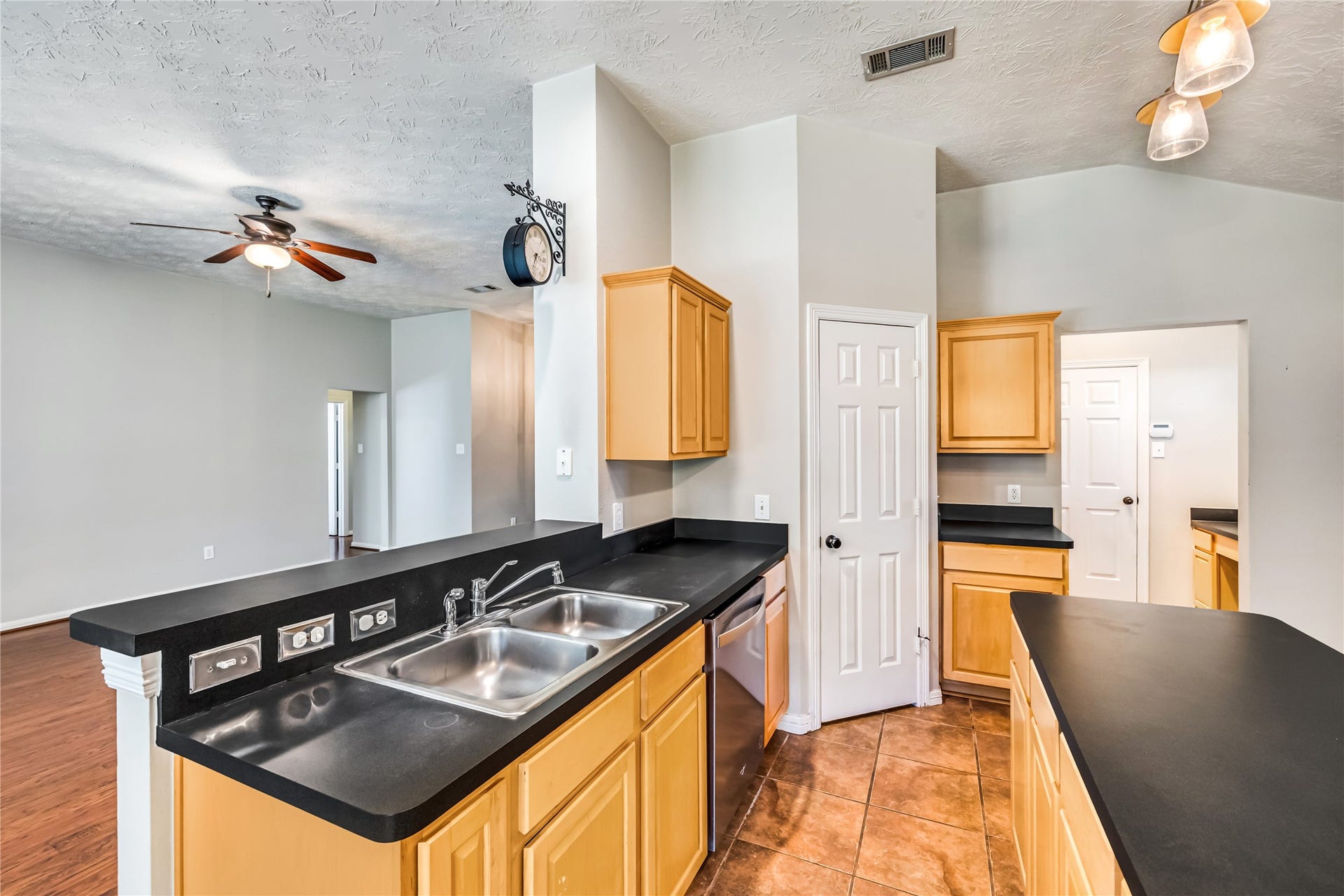 914 Mesquite Drive, Magnolia, TX 77354 Kitchen has breakfast bar, double sink, dishwasher, pantry, an island and lots of storage space.