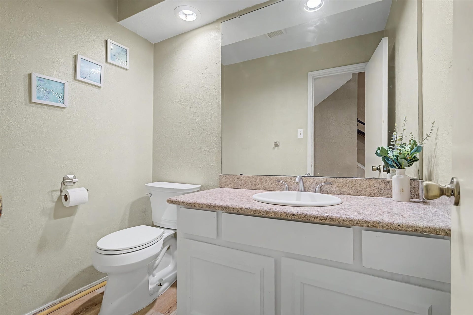 794 Thicket Lane, Houston, TX 77079 Convenient half bath with vanity, large mirror, and recessed lighting.