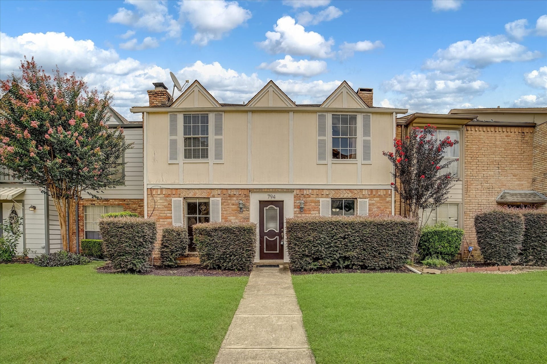 794 Thicket Lane, Houston, TX 77079 Welcome to 794 Thicket! A two-story townhome featuring a brick and stucco exterior, mature landscaping, and a welcoming front walkway.