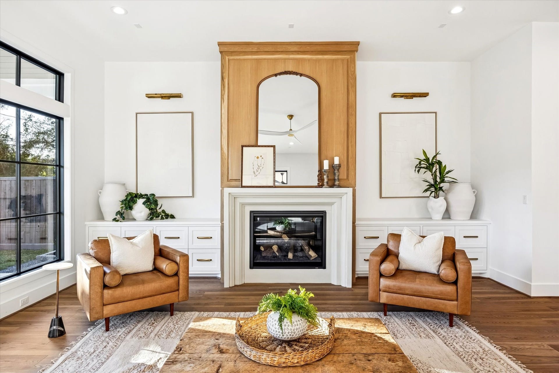 320 W 32nd Street, Houston, TX 77018 Custom millwork fireplace wall anchors the living room with integrated storage and balanced symmetry. Designed as a natural focal point, it adds warmth and architectural presence without overwhelming the surrounding space. **Previous build by Arch Angelo**