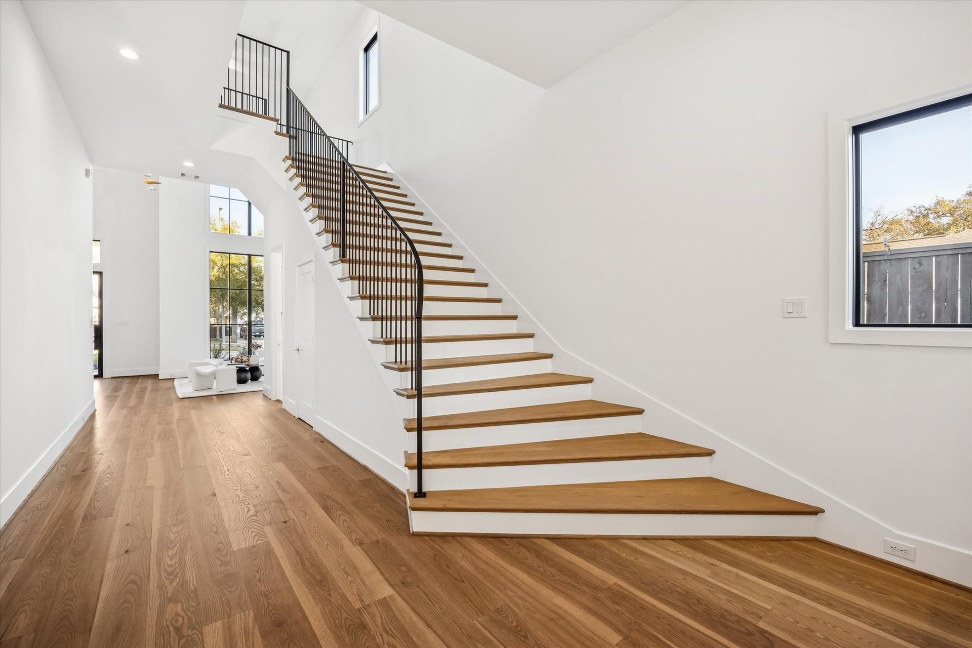 320 W 32nd Street, Houston, TX 77018 Curved staircase serves as a sculptural focal point, guiding movement through the home while preserving open sightlines and natural light. Wide plank floors and clean transitions reinforce a layout designed for both flow and everyday ease. **Previous build by Arch Angelo**