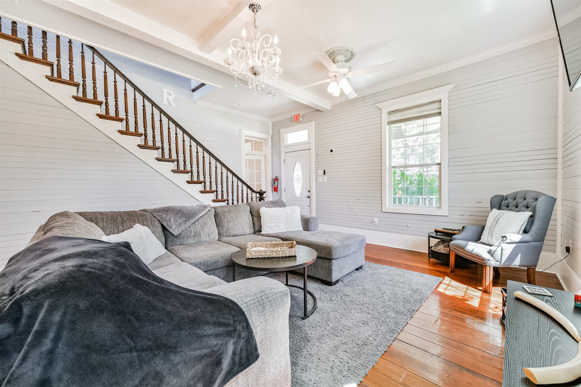503 W Blum Street, Alvin, TX 77511 The original dark walnut staircase is a stunning centerpiece and piece of the homes 1890 craftsmanship.