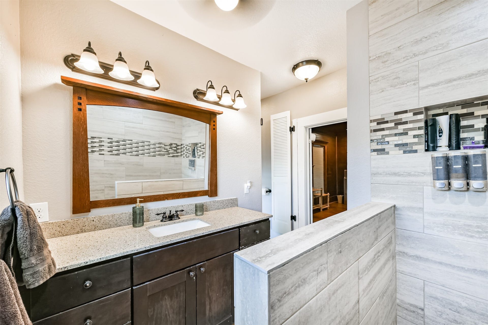 503 W Blum Street, Alvin, TX 77511 Updated vanity, generous counter space and stylish finishes complete the remodeled upstairs bath.