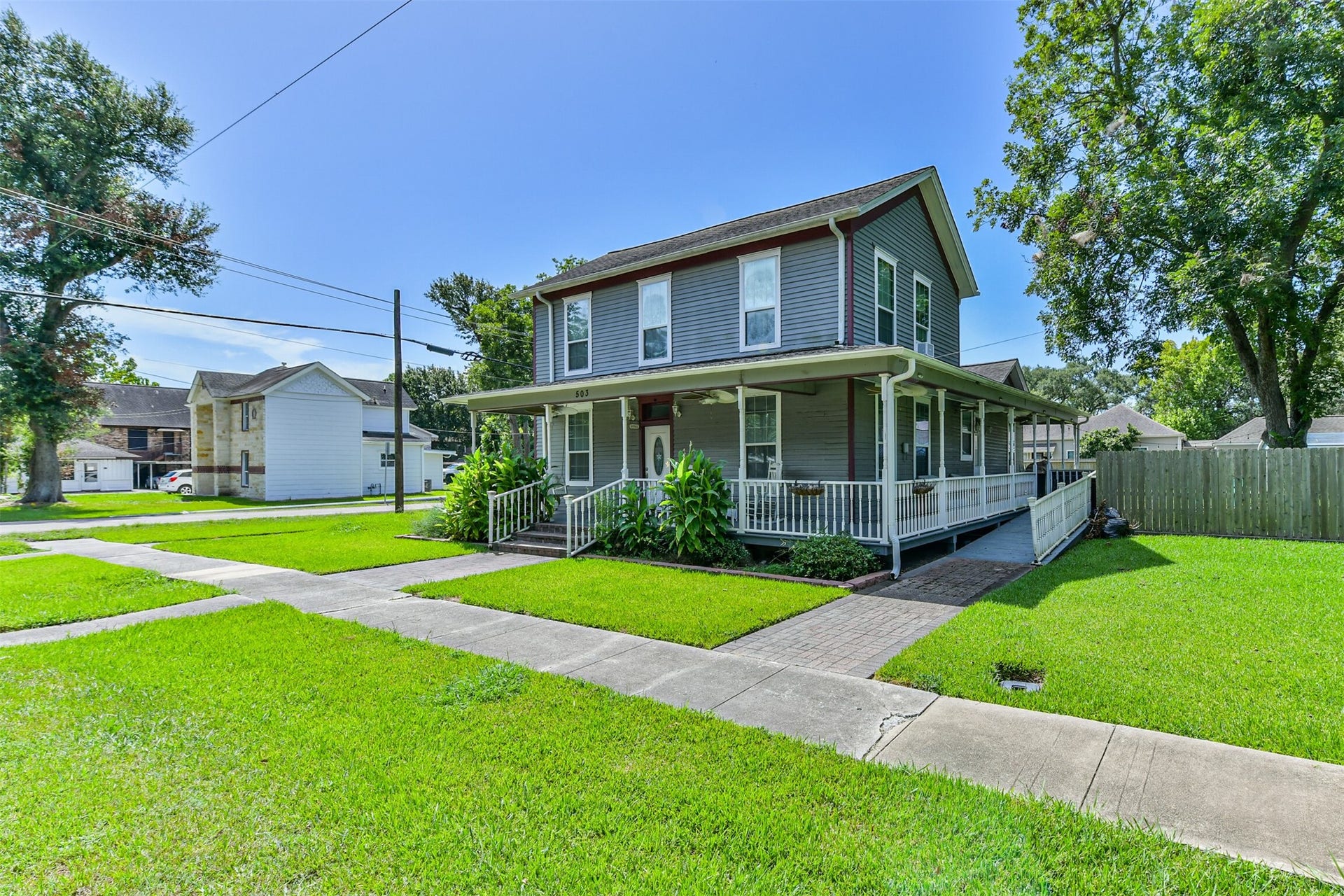 503 W Blum Street, Alvin, TX 77511 Multiple porches and a sprawling lawn add to this historic homes Southern charm.