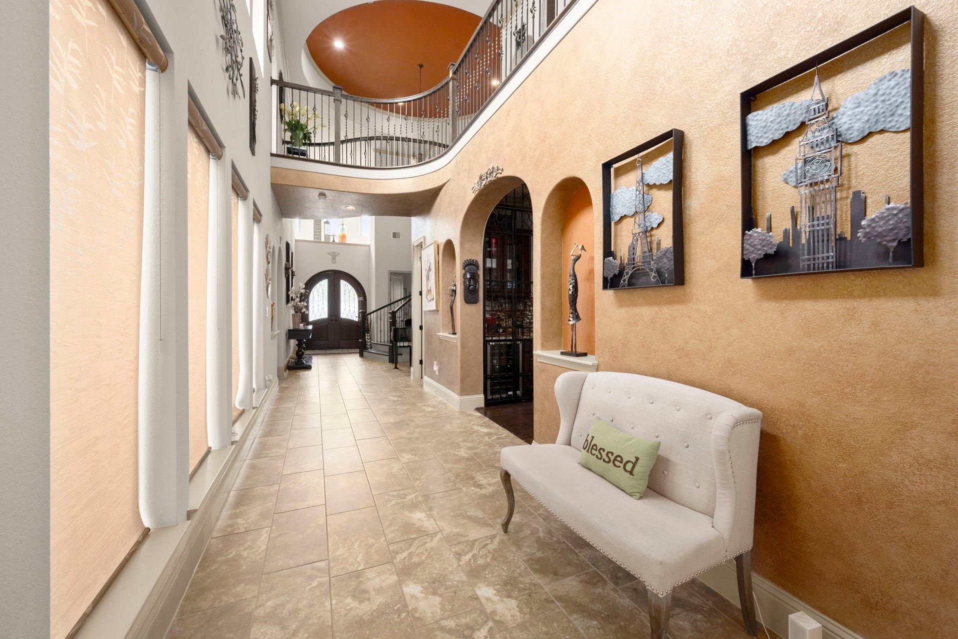 5103 Jackson Ponds Court, Sugar Land, TX 77479 This hallway features the high ceilings, a grand staircase, large windows and an entryway to the designated dining room.