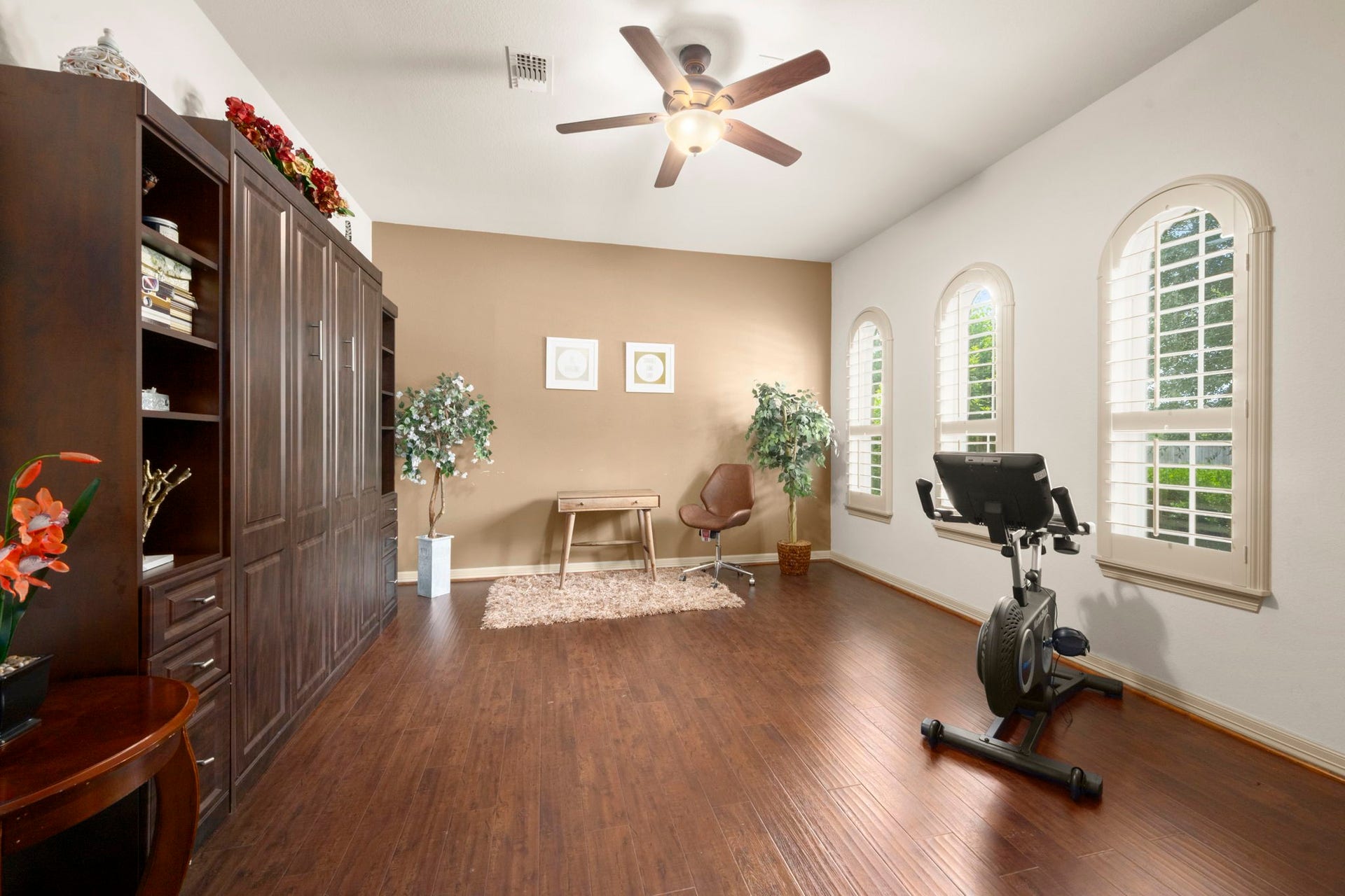 5103 Jackson Ponds Court, Sugar Land, TX 77479 This bright, versatile room features rich wood flooring and built-in shelving - perfect for another home office, gym, or bedroom.