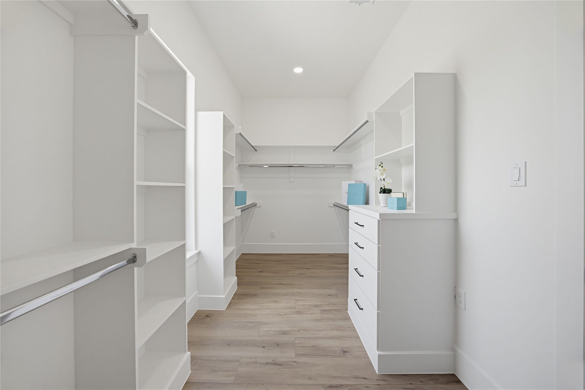 1004 E 35th Street, Houston, TX 77022 Spacious walk-in closet with custom shelving and drawers, offering ample storage and a sleek, modern design.