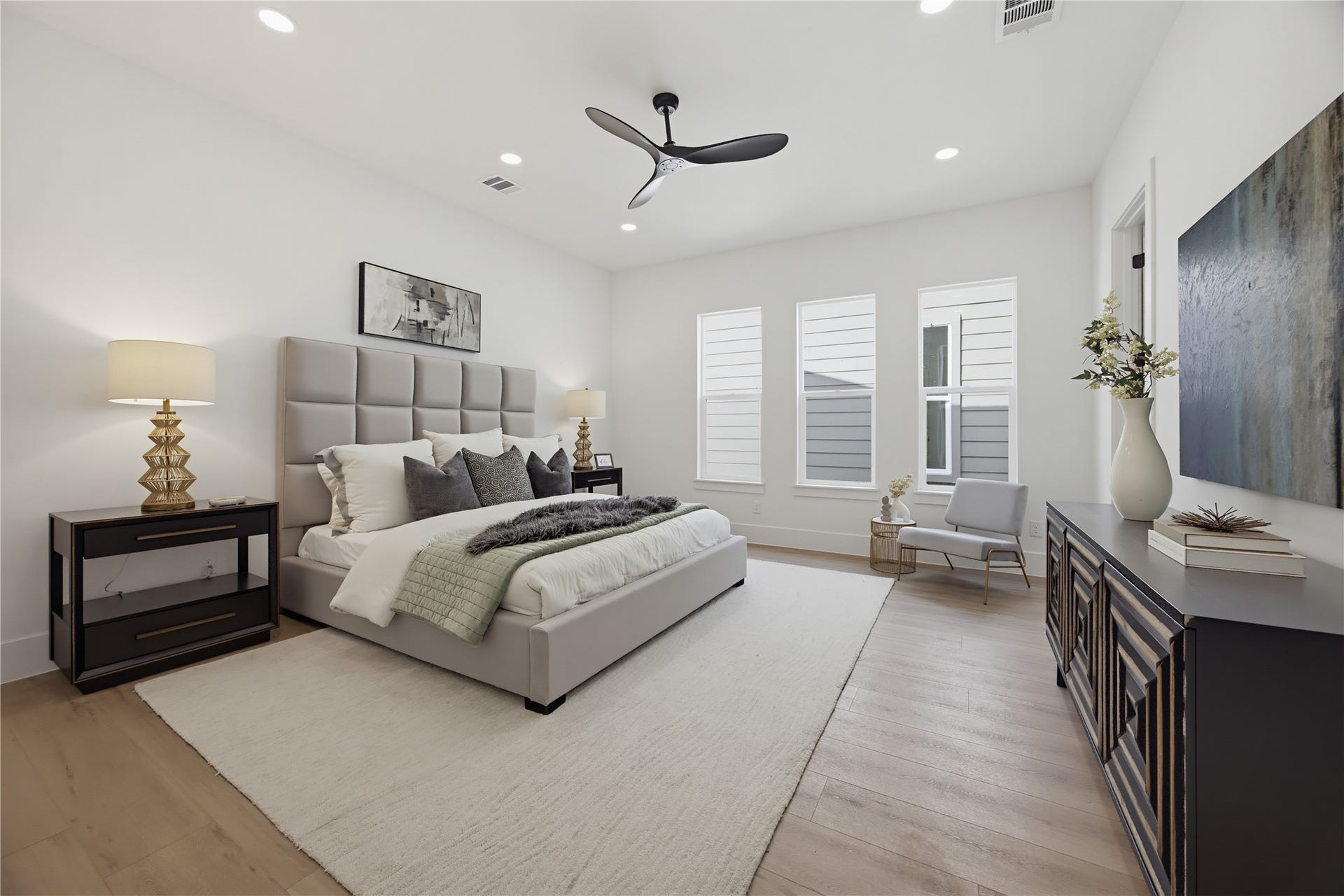 1004 E 35th Street, Houston, TX 77022 Elegant and spacious primary bedroom. Natural light pours in through tall windows, highlighting the serene ambiance.