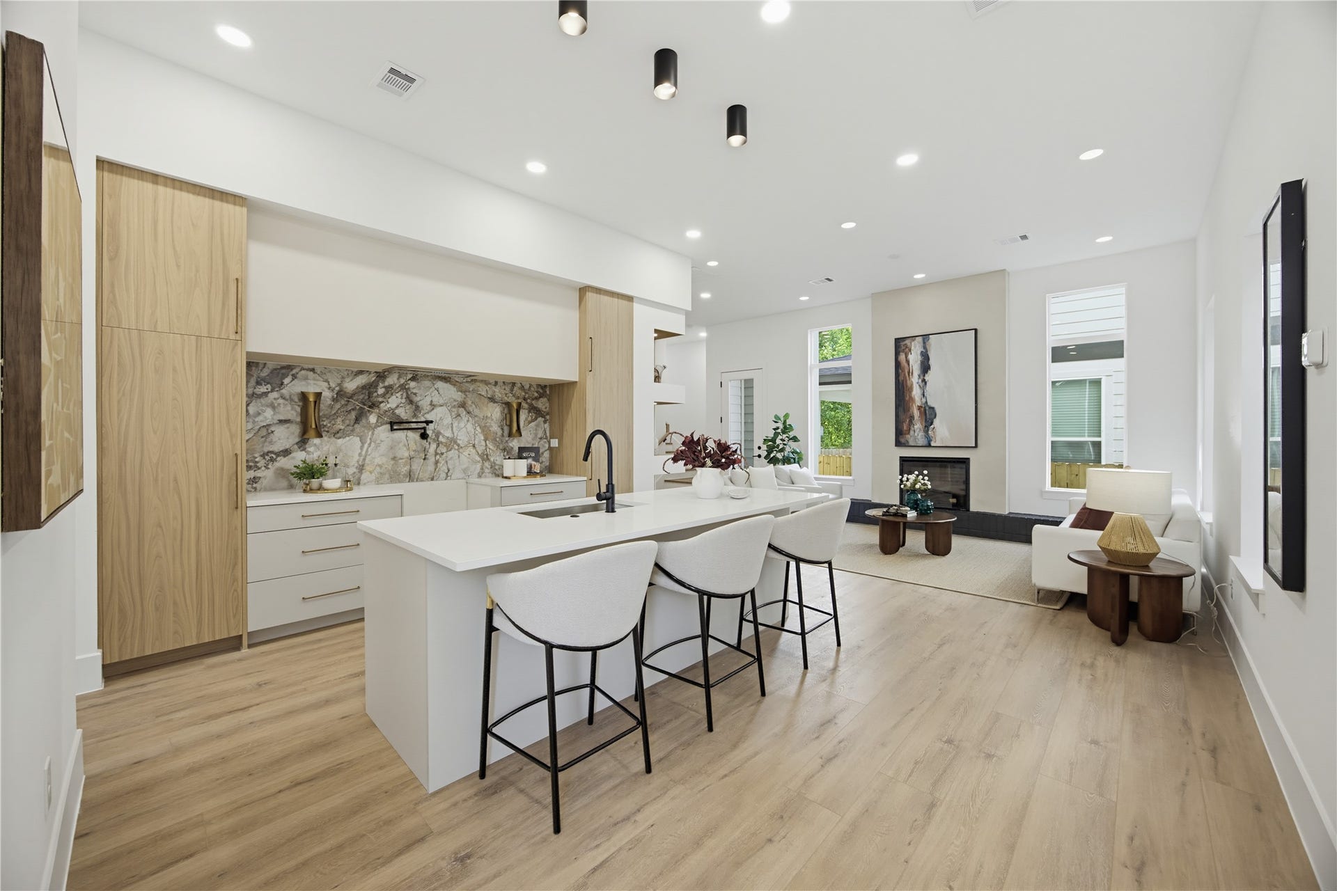 1004 E 35th Street, Houston, TX 77022 Experience modern elegance in this open-concept kitchen and living area, featuring sleek cabinetry, a stylish waterfall island, and abundant natural light.