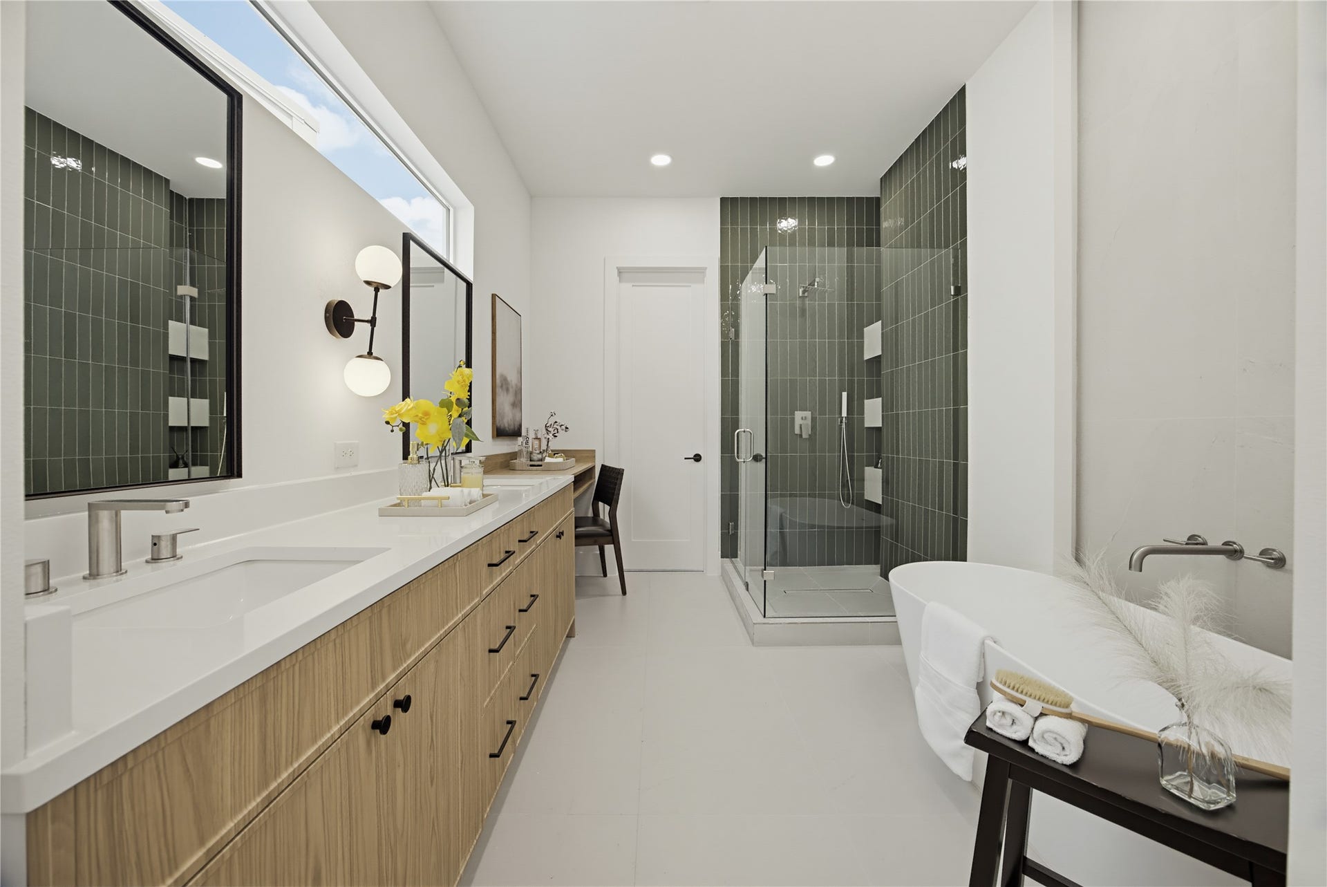 1004 E 35th Street, Houston, TX 77022 Luxurious bathroom featuring a sleek double vanity with ample storage, a modern glass-enclosed shower, and a freestanding soaking tub for ultimate relaxation.