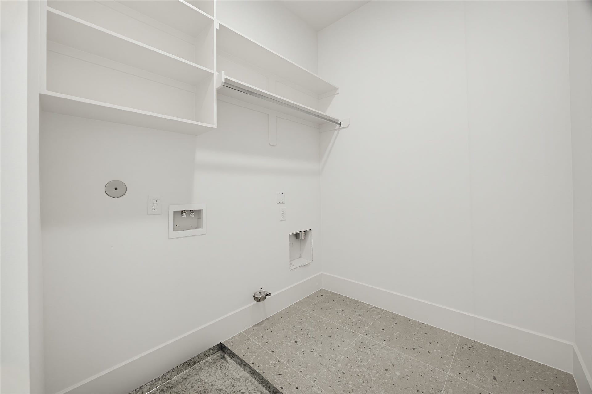 1004 E 35th Street, Houston, TX 77022 Spacious laundry room with built-in shelving, ample storage, and washer/dryer hookups, perfect for organizing your laundry essentials.
