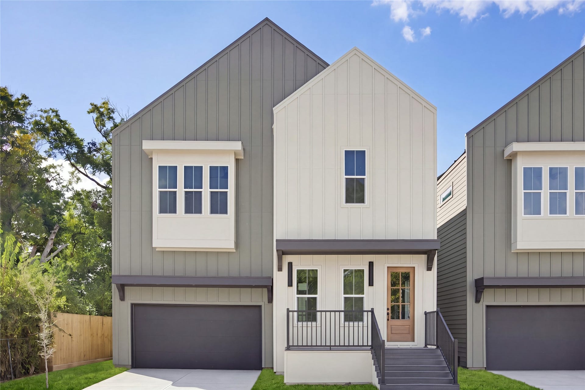 1004 E 35th Street, Houston, TX 77022 Modern two-story home with a sleek facade, featuring a welcoming front porch, stylish siding, and a spacious two-car garage.