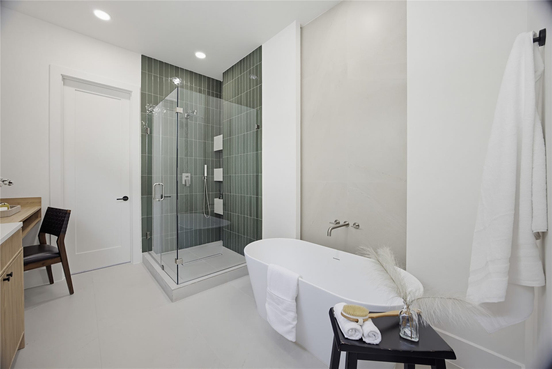 1004 E 35th Street, Houston, TX 77022 Experience luxury in this modern bathroom featuring a sleek glass-enclosed shower and a freestanding soaking tub. Elegant fixtures and a serene color palette complete the sophisticated look.
