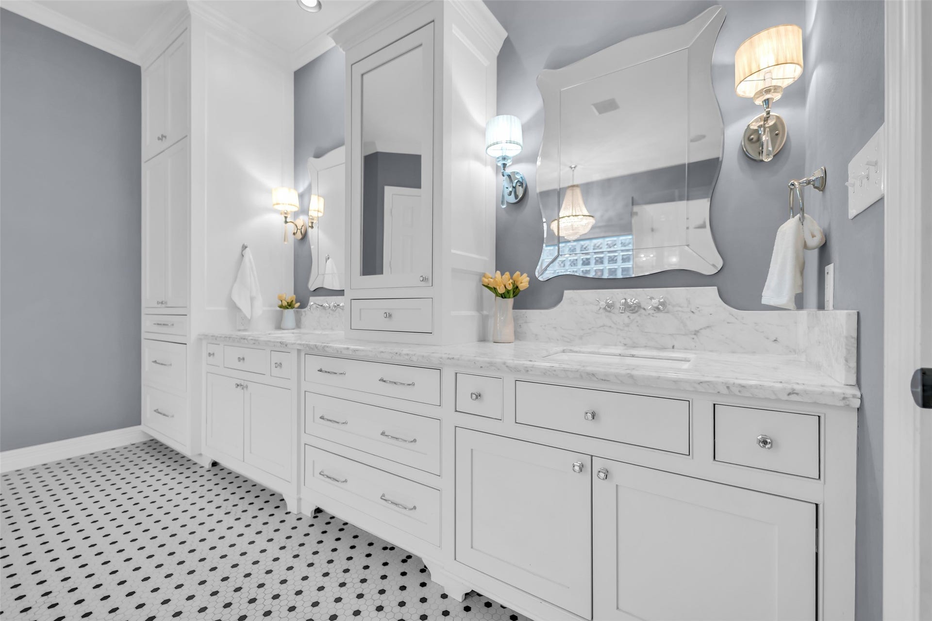 8703 Stones Throw Lane, Missouri City, TX 77459 Ensuite primary bathroom showcases elegance with Carera marble counters, custom mirrors, wall sconce lighting and custom cabinets.
