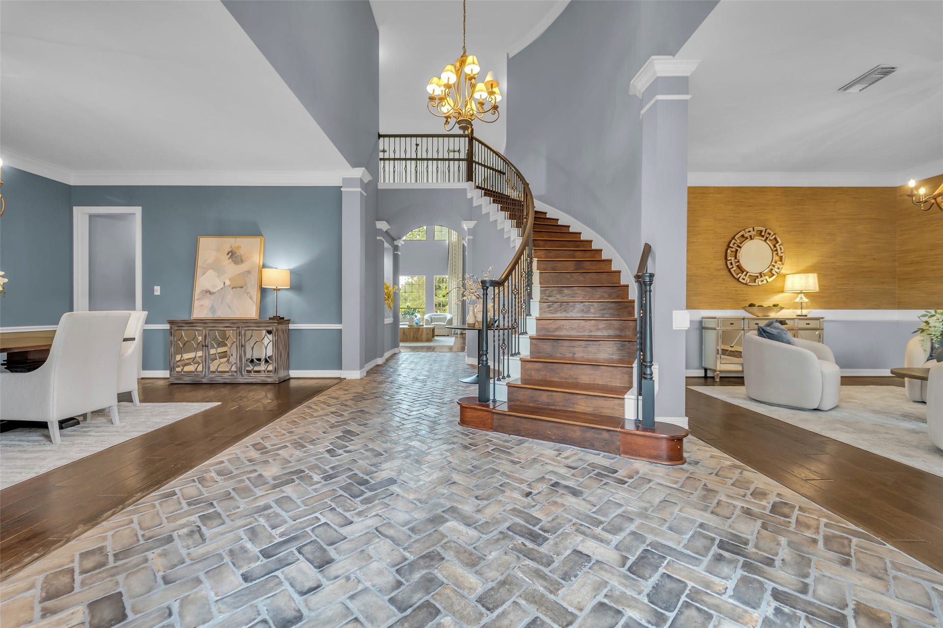 8703 Stones Throw Lane, Missouri City, TX 77459 You are welcomed by a breath taking foyer with high ceiling, chandelier, spiral staircase and unique brick flooring.