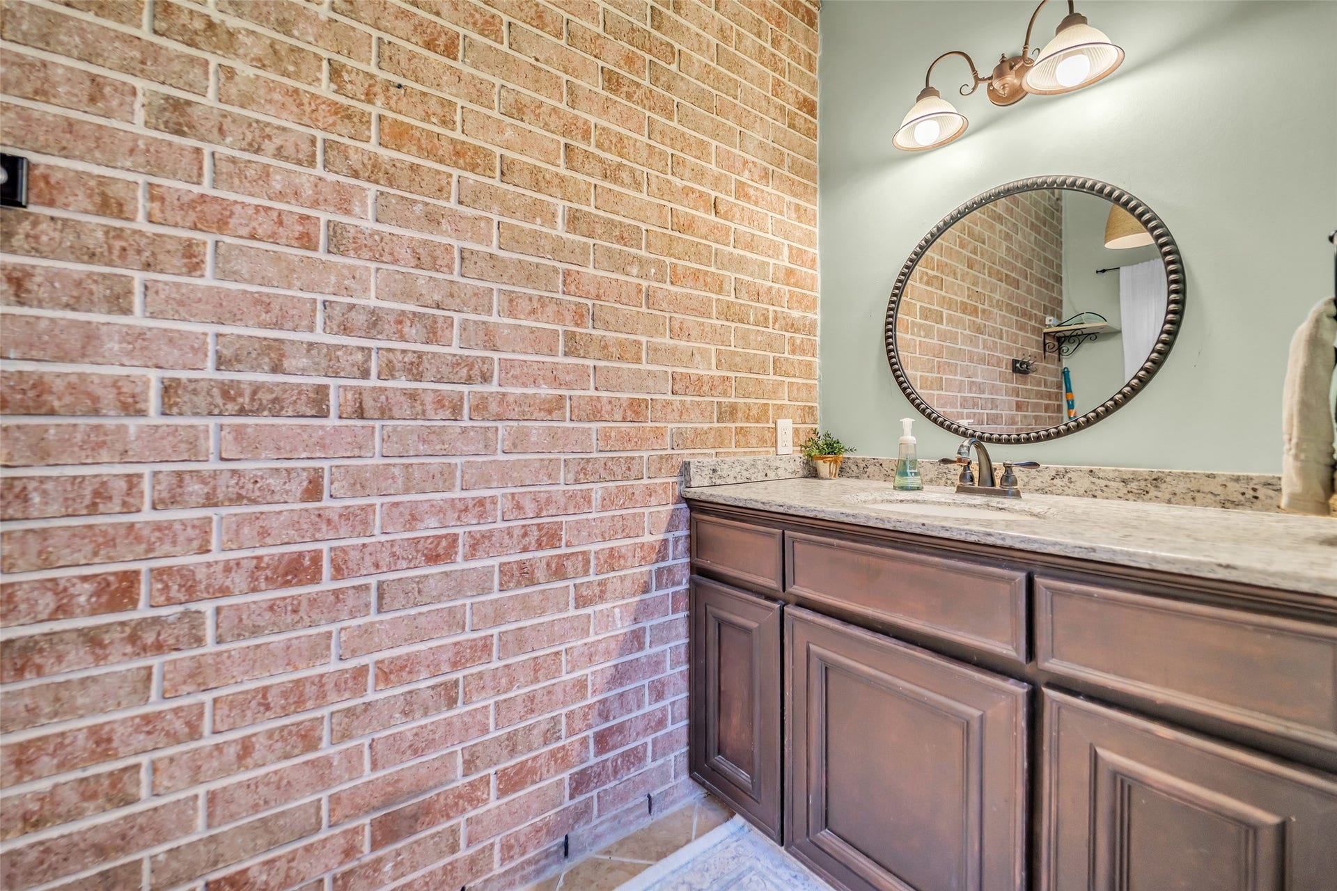 8703 Stones Throw Lane, Missouri City, TX 77459 Another treasure! - An outdoor half bath with tile flooring, granite countertop and chandelier lighting.