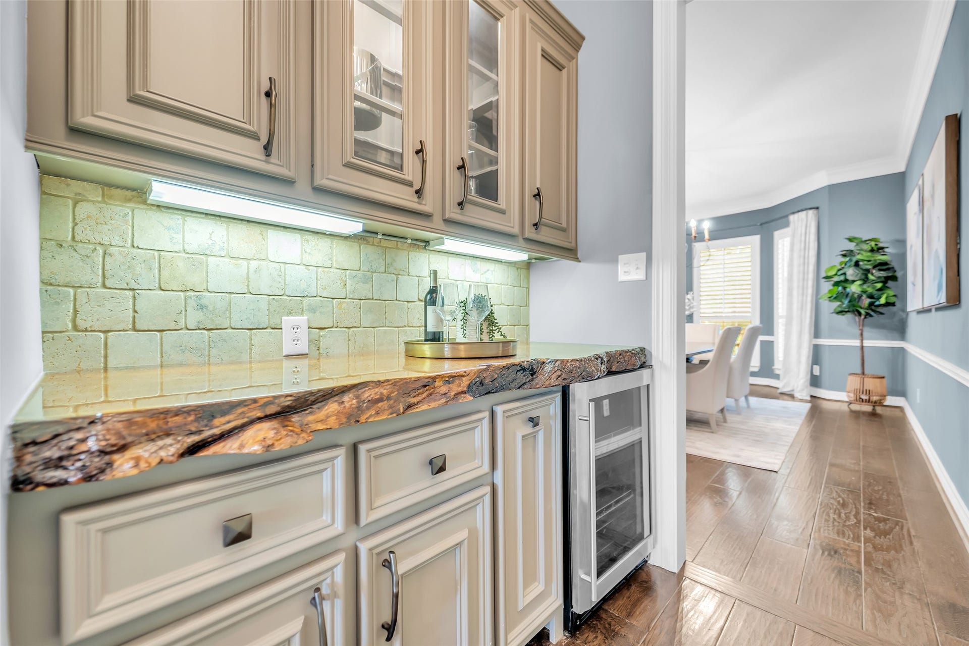 8703 Stones Throw Lane, Missouri City, TX 77459 A butlers pantry - an added bonus - with exotic wood living-edge countertop, glass front cabinets, stone backsplash and beverage refrigerator.