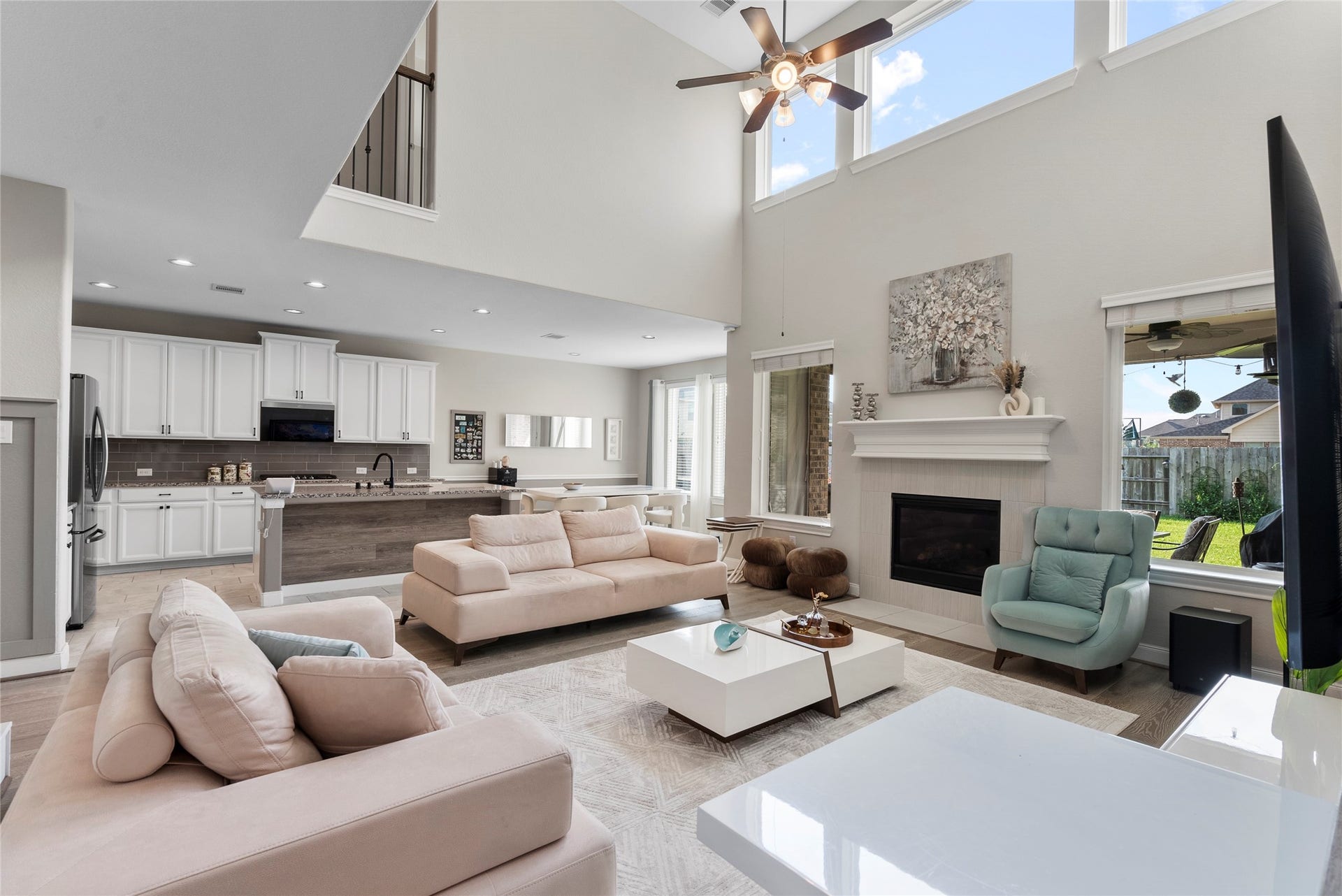 living room w high ceiling and hardwood floors