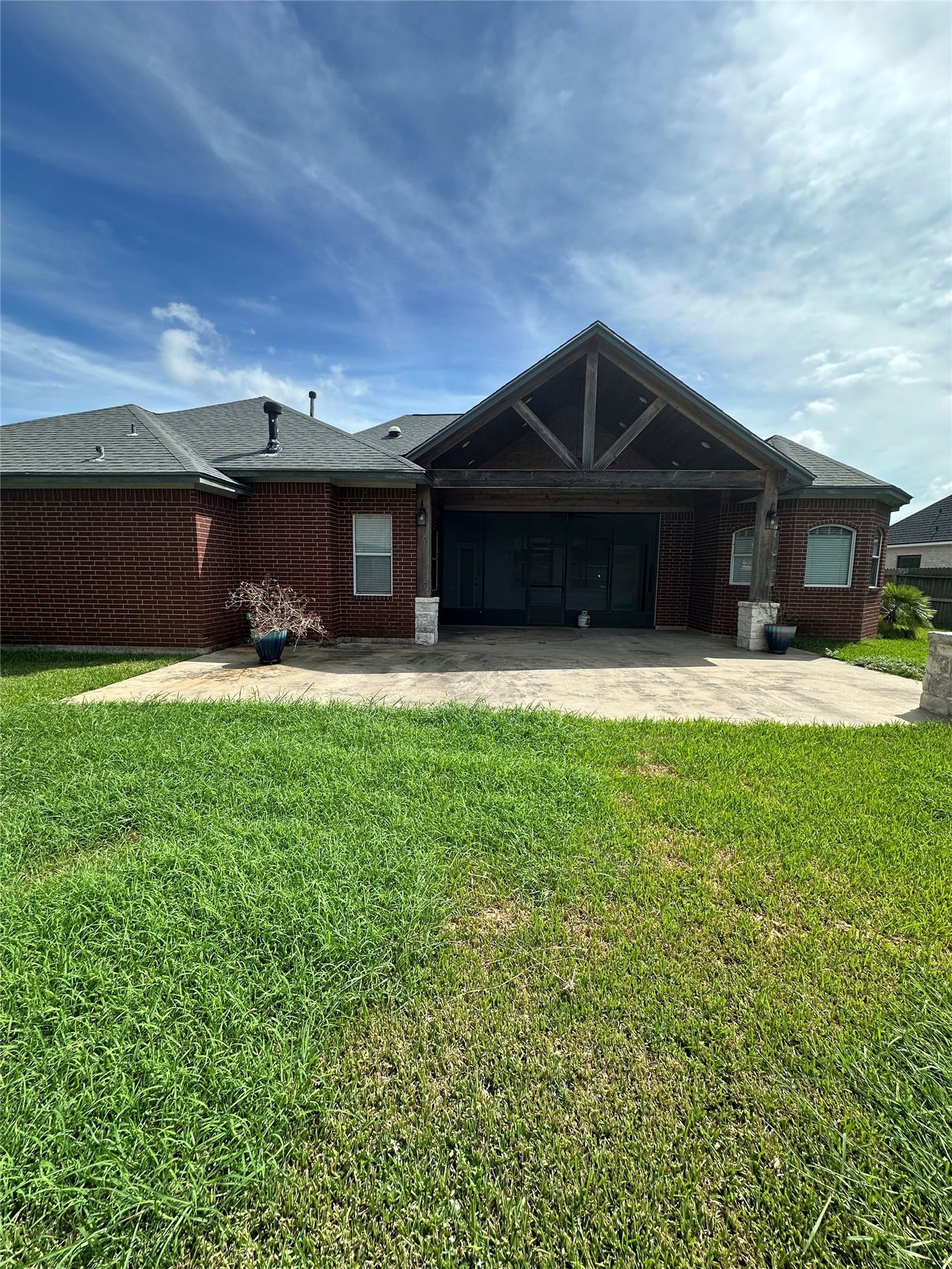 101 Mallard Drive, Clute, TX 77531 Covered patio with a screened-in section, perfect for year-round outdoor entertaining and enjoying the backyard views in comfort.