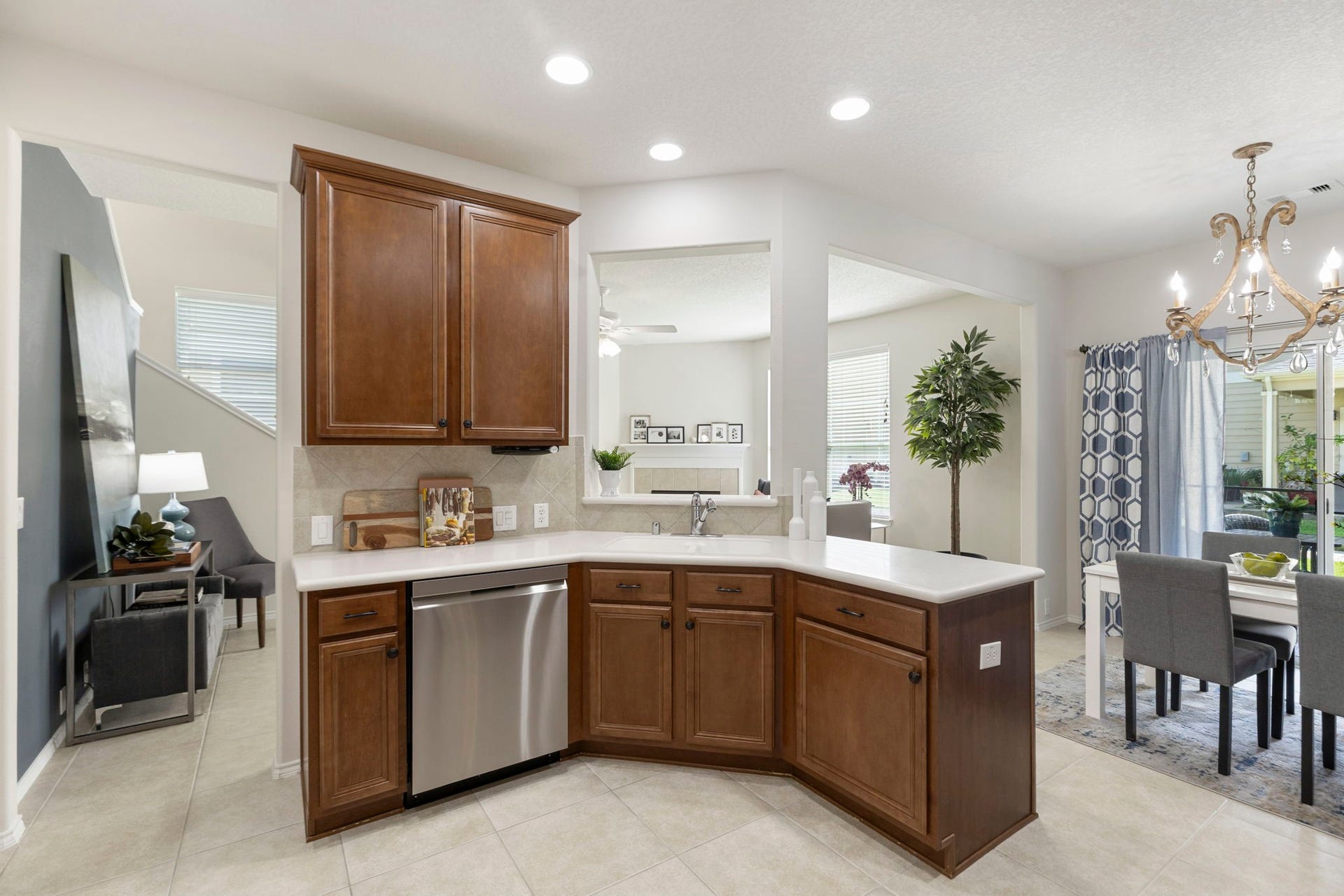 13600 Breton Ridge Street, #11A, Houston, TX 77070 This view highlights the easy flow between the kitchen, dining and living areas. The beautiful blue accent wall (seen at the left) would be ideal as a sitting / reading area, a drop zone or a holiday buffet / bar area.